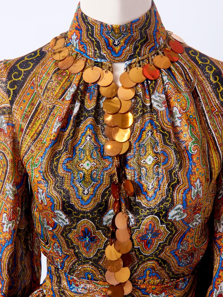 Donald Brooks, paisley pattern, copper lurex, dress and harem pant ensemble. Dress has a high neckline, with long sleeves and a gathered self belted waist. Oversize copper paillettes, embellish the dress at the neckline and cuffs. Harem pant is