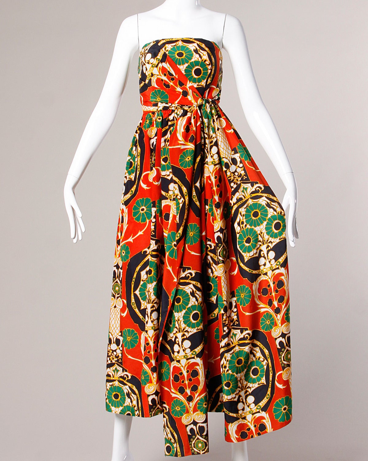 Reduced from $1895. Stunning vintage two-piece ensemble by Donald Brooks featuring a strapless wrap-style gown and matching capelet. Both pieces are done in a vibrant Asian-inspired printed creamy silk and can be worn separately as well as together