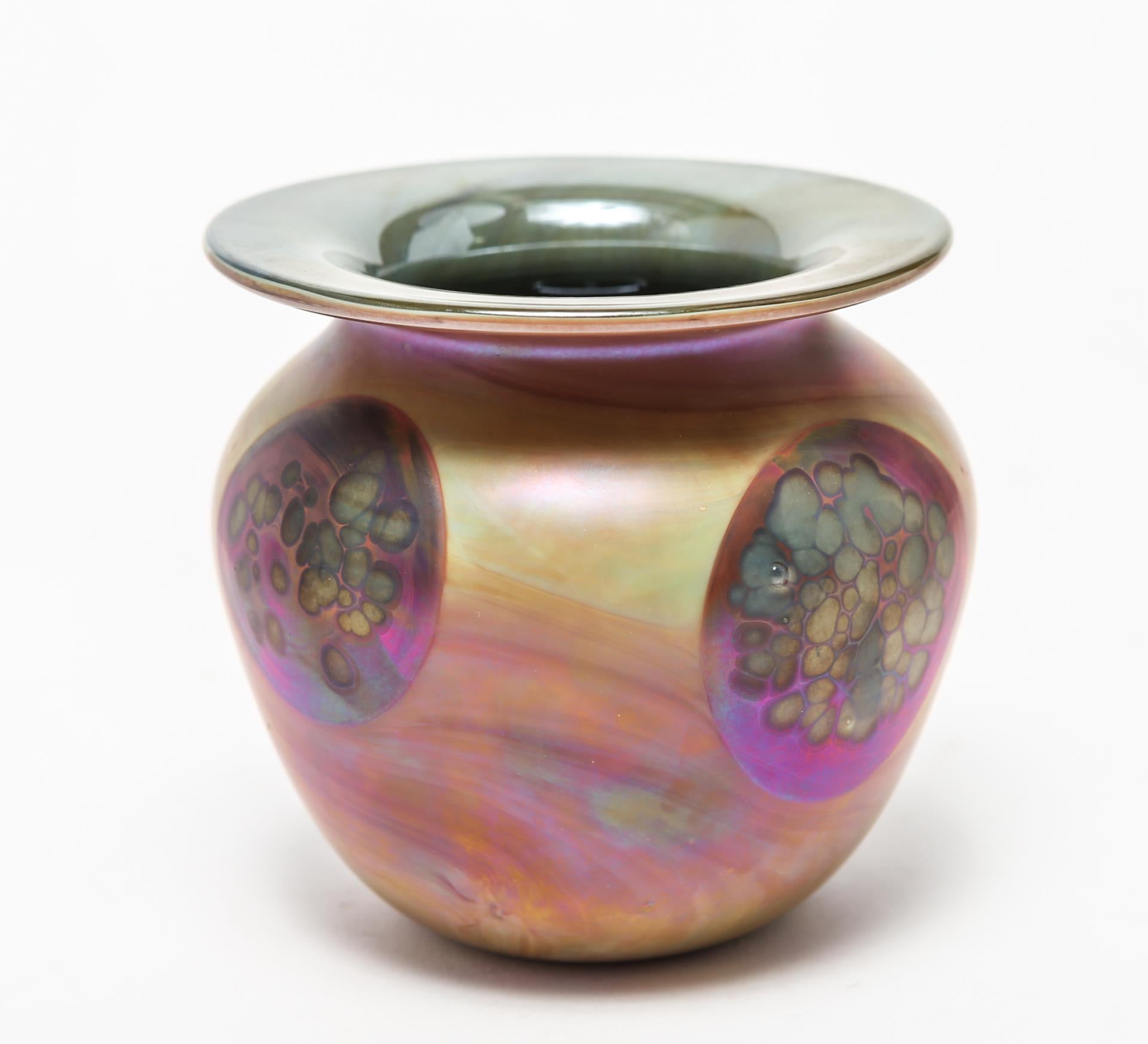 American modern art glass vase made by Donald Carlson in swirled orange and pink luster glass with circular medallions. The piece has an etched signature underneath and is marked 