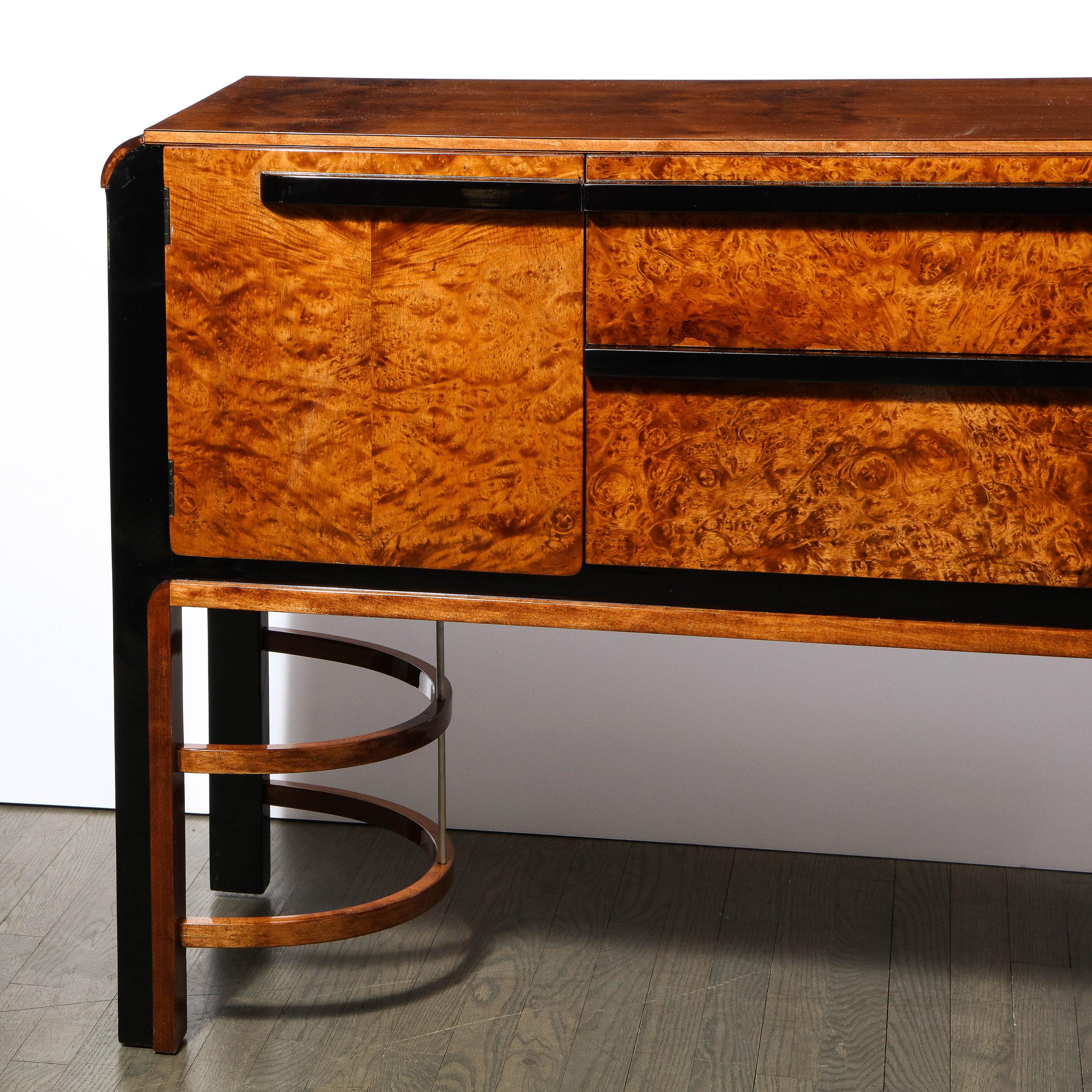 This stunning Art Deco Machine Age sideboard was designed by Donald Deskey (the visionary behind Radio City Music Hall) and realized for the Widdicomb Furniture Company in the United States, circa 1935. It features a burled carpathian elm front with