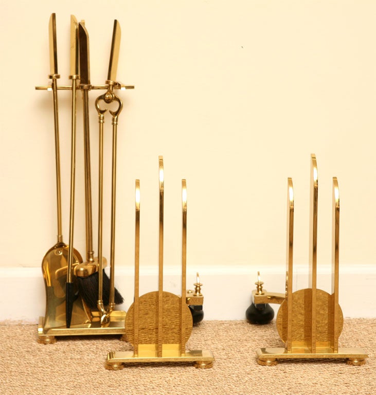 This great Donald Deskey polished and lacquered solid brass Art Deco moderne andirons and fireplace tool set are stellar. These are timeless and modernist. These came from amazing collectors! These are from the 1930s and are rare. These are a