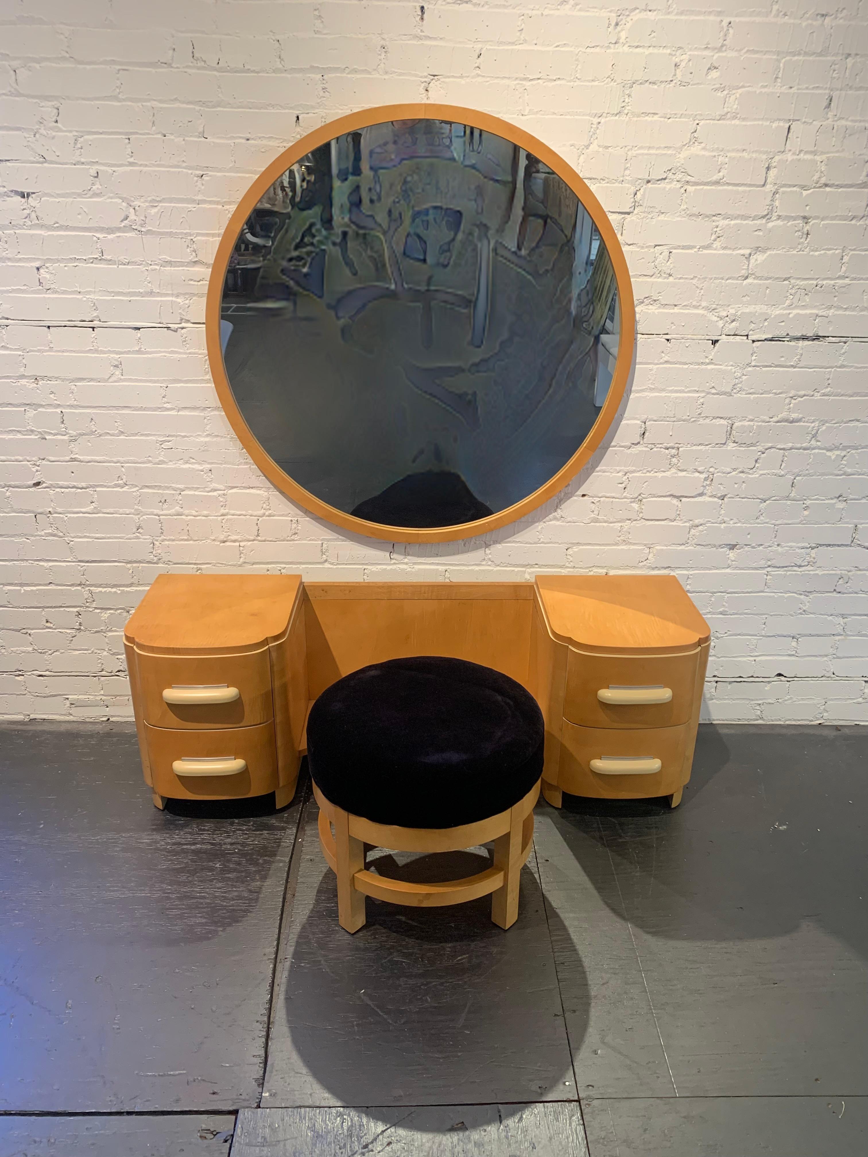 Wonderful period streamline Art Deco design vanity dressing table & vanity stool with large round mirror by Donald Deskey (1894-1989) for Widdicomb furniture in maple veneer with aluminum details. Cream lacquered handles and highlights. Mirror is
