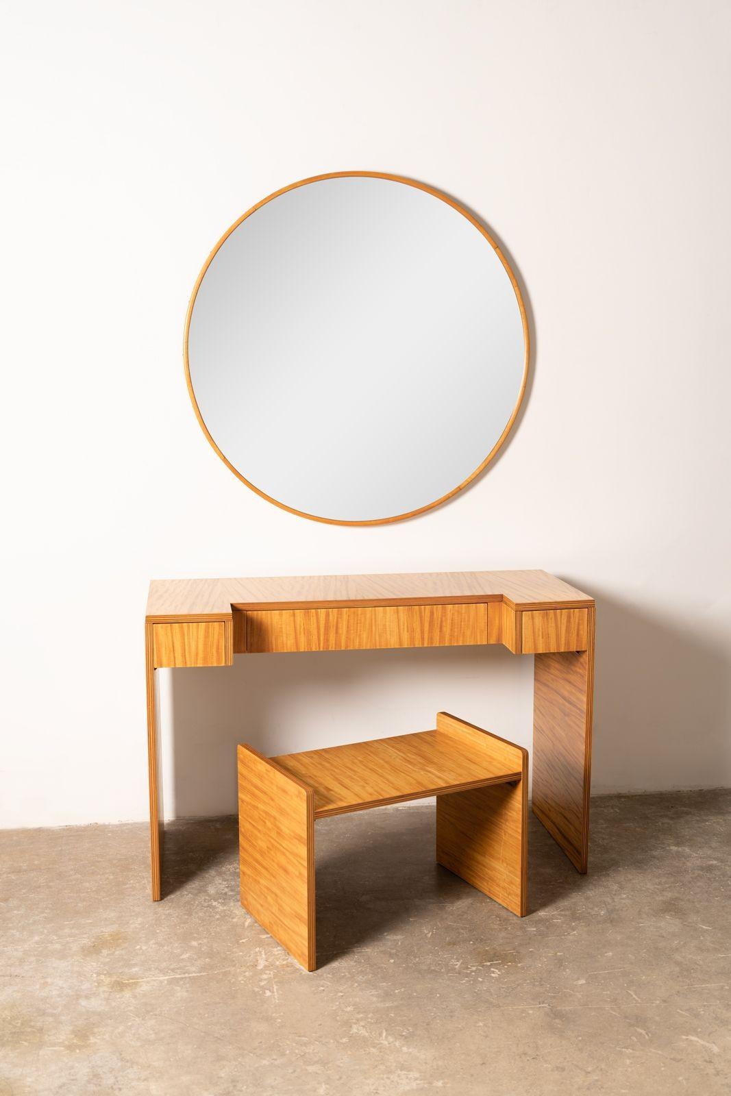 Extraordinary vanity table with mirror and stool crafted from highly figured ribbon Avodire wood. Created by the Holland Furniture Company in the 1940s. Donald Deskey at this time was designing for the Baker furniture company which had just