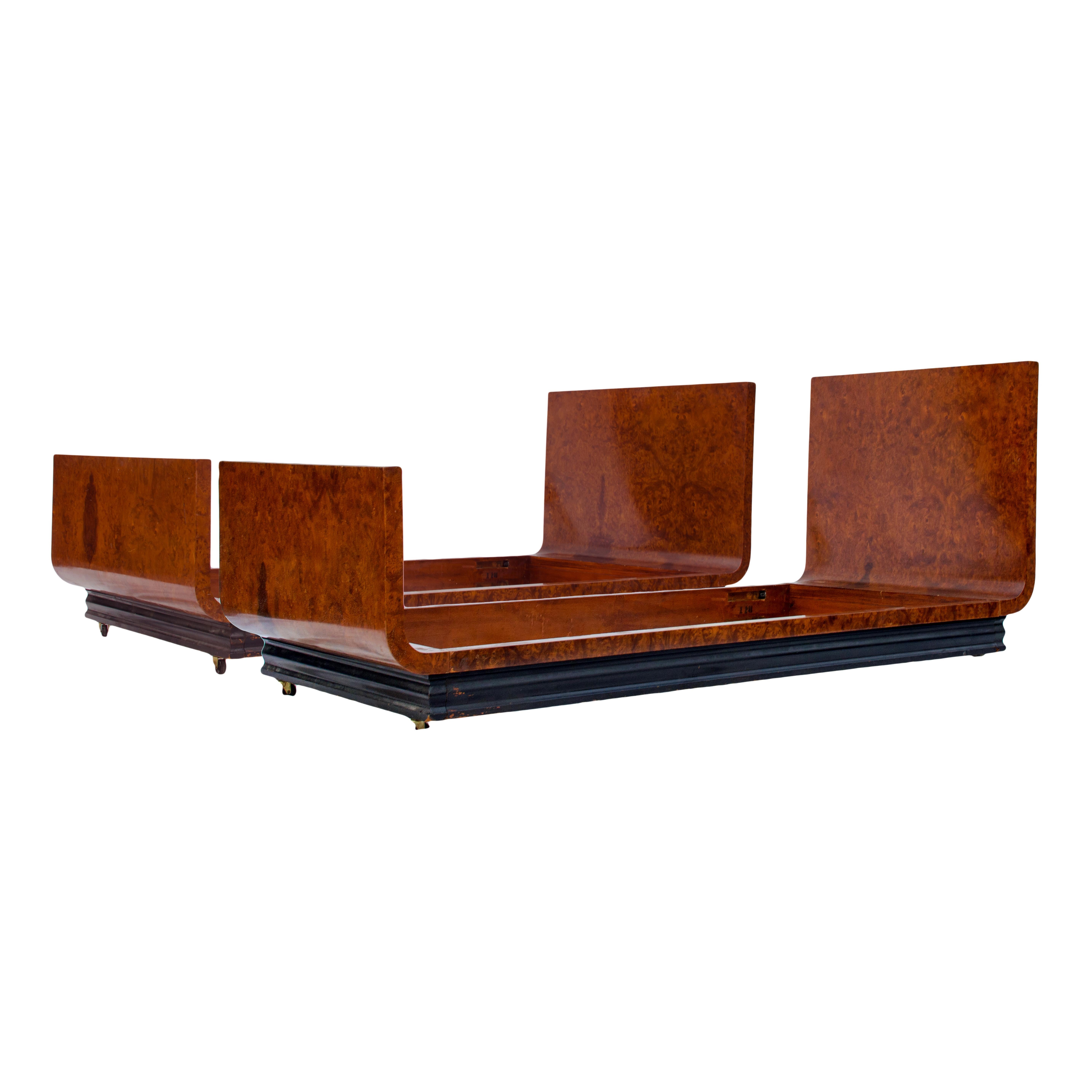 Donald Deskey
(American, 1894-1989)

Important twin bed frames by Donald Deskey for Widdicomb Co. made circa 1935.  Striking carpathian elm burl veneer with original finish.  Comprised of a massive bent laminate substrate the streamlined form rests