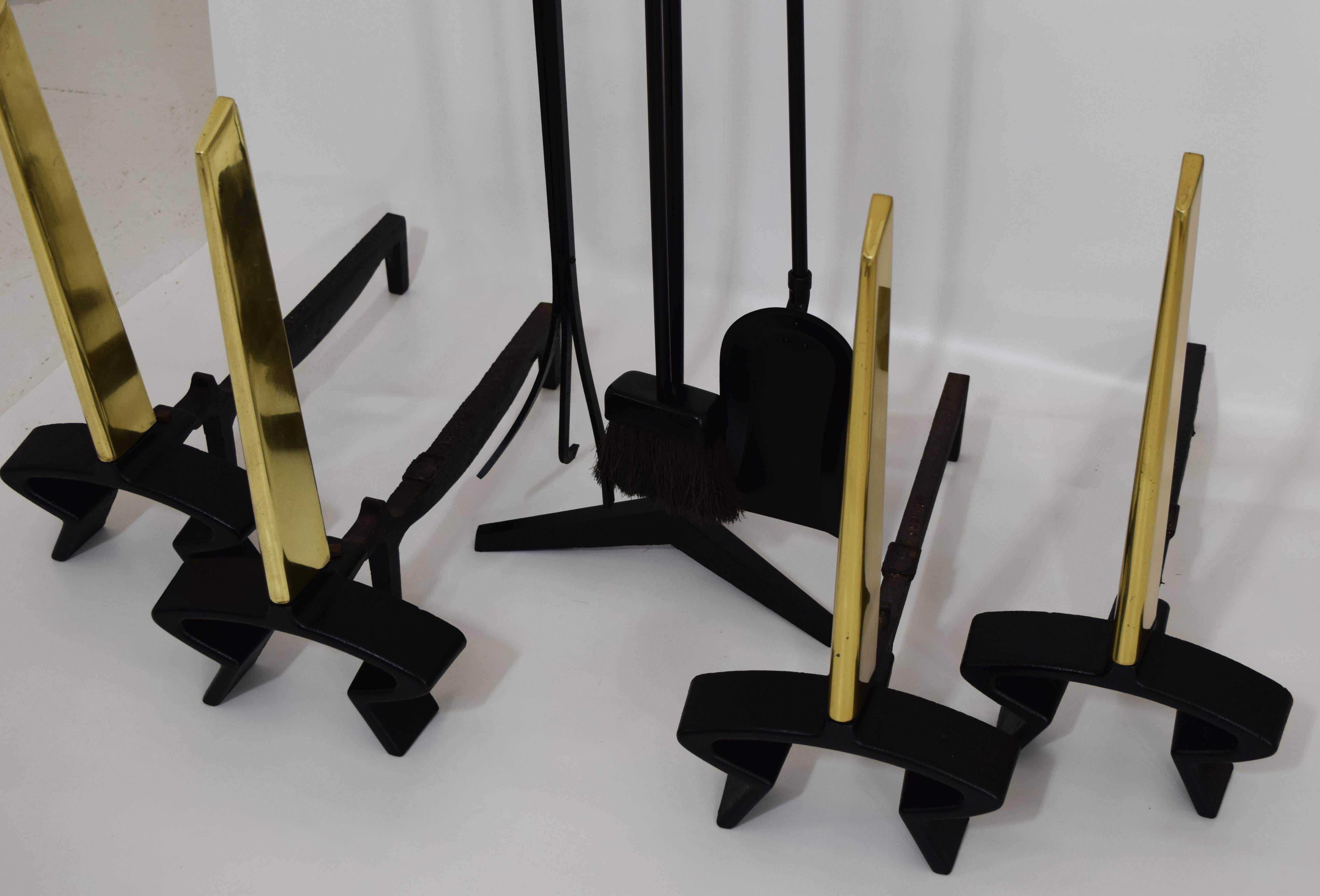 Circa 1950, 8 Piece Mid-Century Modern fireplace tool set and Andirons (4) by Donald Deskey for Bennett, all Andirons are signed. Tool set comes with log grabber with ring, and is also a poker, shovel and brush. The owner had 2 fireplaces and one