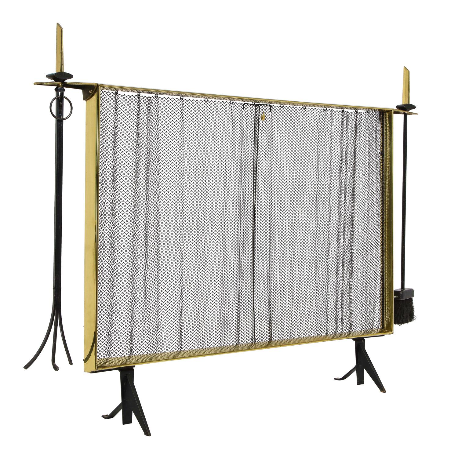 Fireplace screen with pulley system to open and close in wrought iron and brass with tools mounted at sides by Donald Deskey for Bennett, American 1950's. This is an unusual combination with the tools mounted right on the screen.