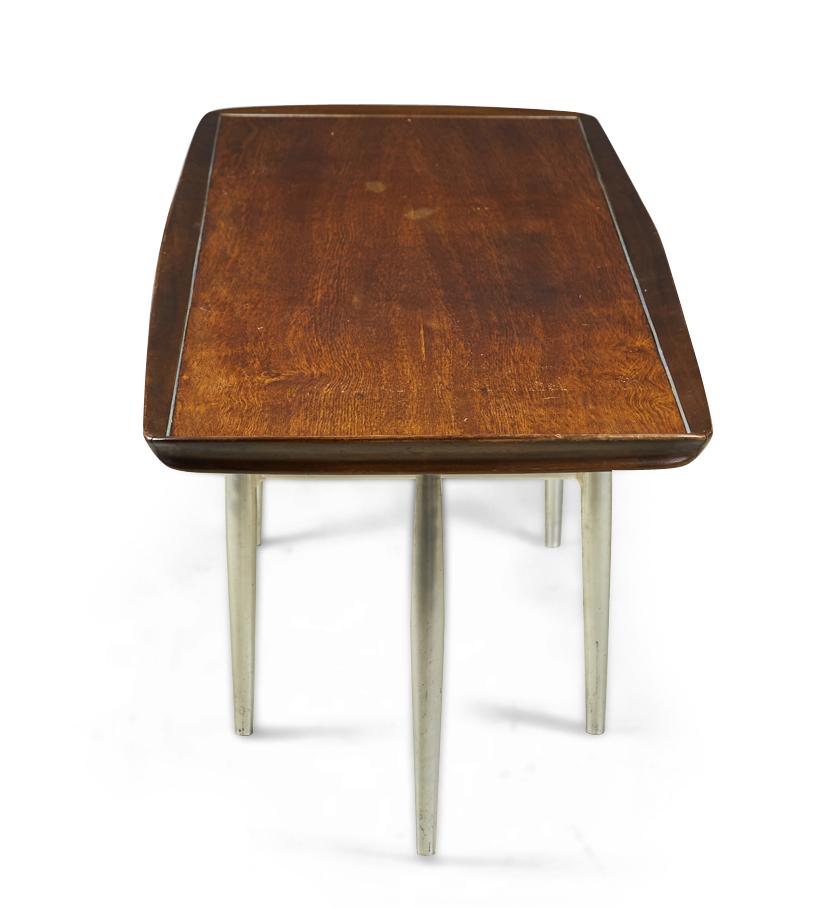 American Mid-Century (circa 1950) 'Surfboard' coffee table with a rosewood table top resting on an aluminum stretcher base with six tapered legs. (DONALD DESKEY FOR CHARAK MODERN).