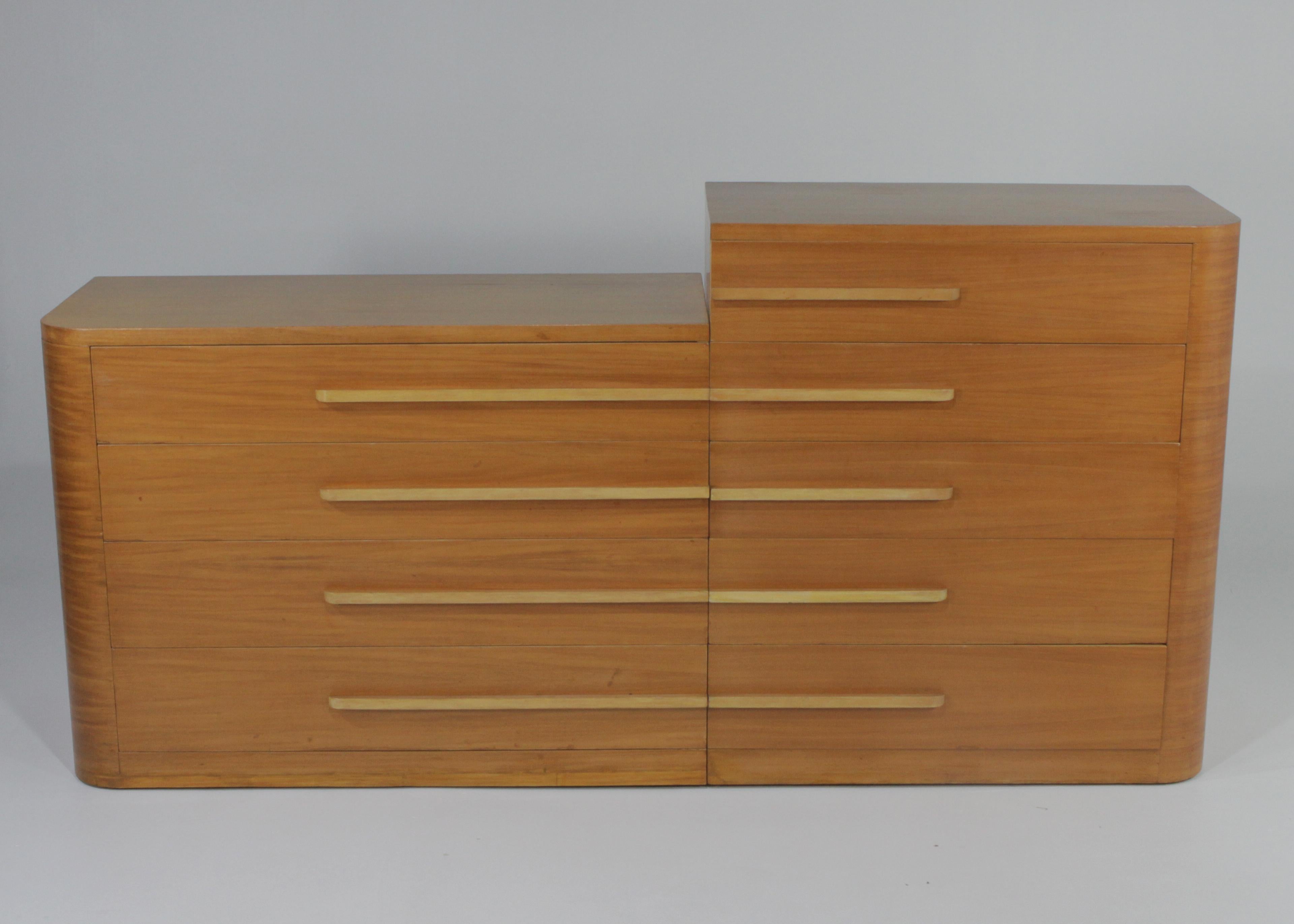 Stunning Art Deco Moderne dresser 2-piece set designed by Donald Deskey for Widdicomb. Unmarked. Sleek, long horizontal lines in two streamline forms, each with one rounded end and graduated drawers with elongated lacquered wood pulls. The wood