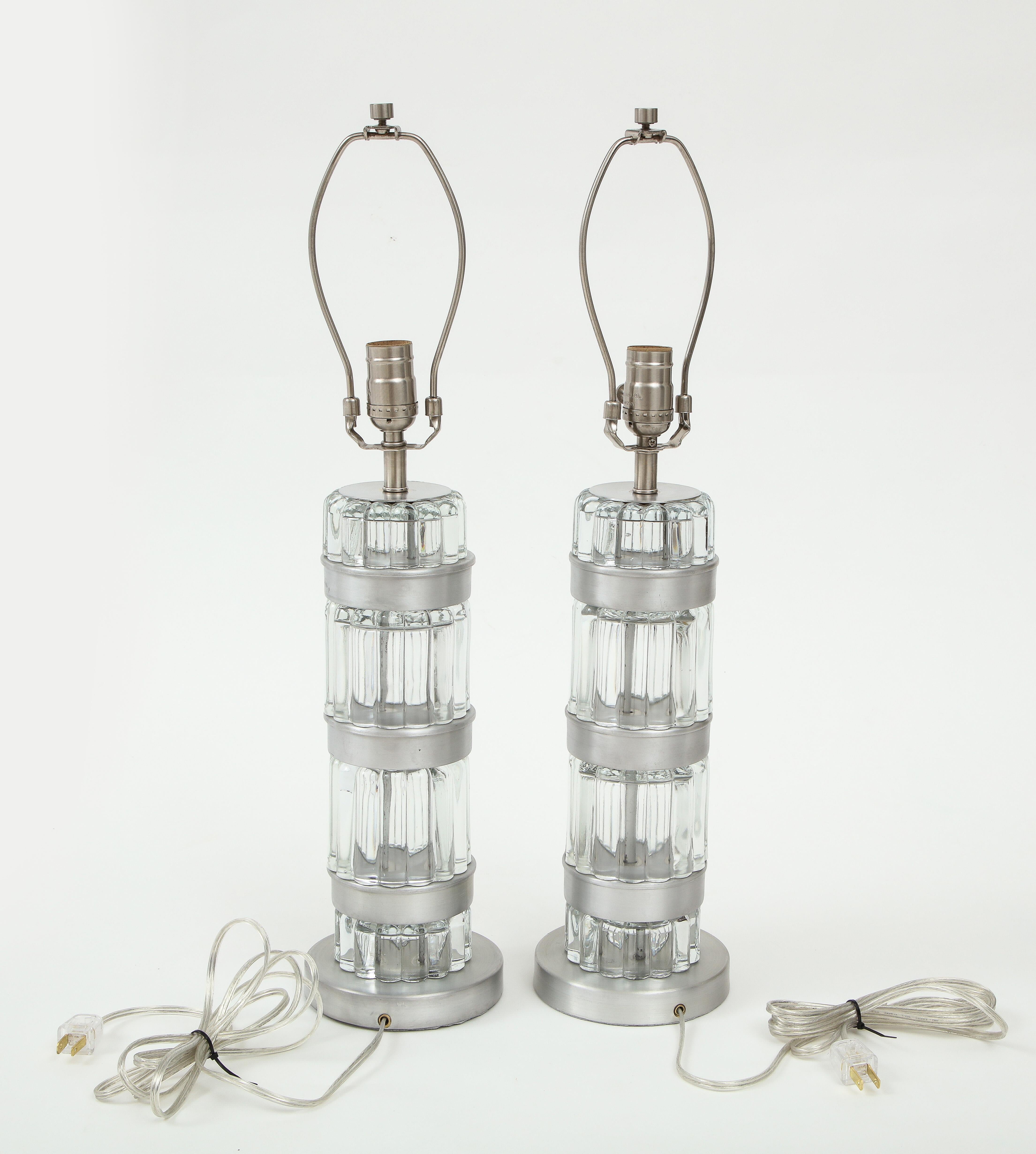 Donald Deskey Machine Age lamps featuring heavy fluted glass elements and spun aluminum discs. Rewired for use in the USA with nickel hardware.

Available at 200 Lexington Ave, 10th floor.