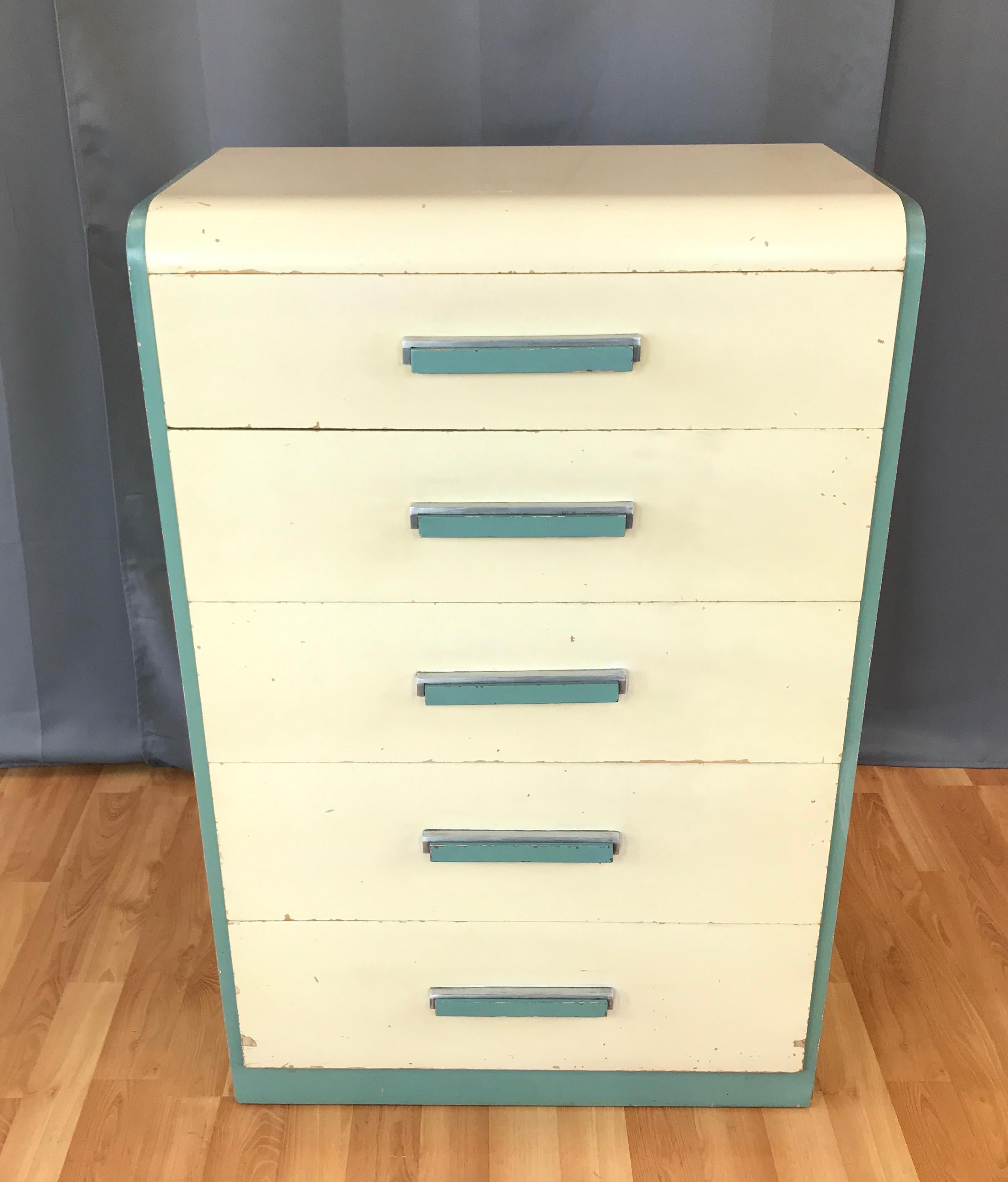 Offered here is a circa 1930s high boy dresser designed by Donald Deskey for Widdicomb Furniture Company of Grand Rapids.

In its original paint color. This example evokes streamliner feel of the high Art Deco style with nautical celadon green and