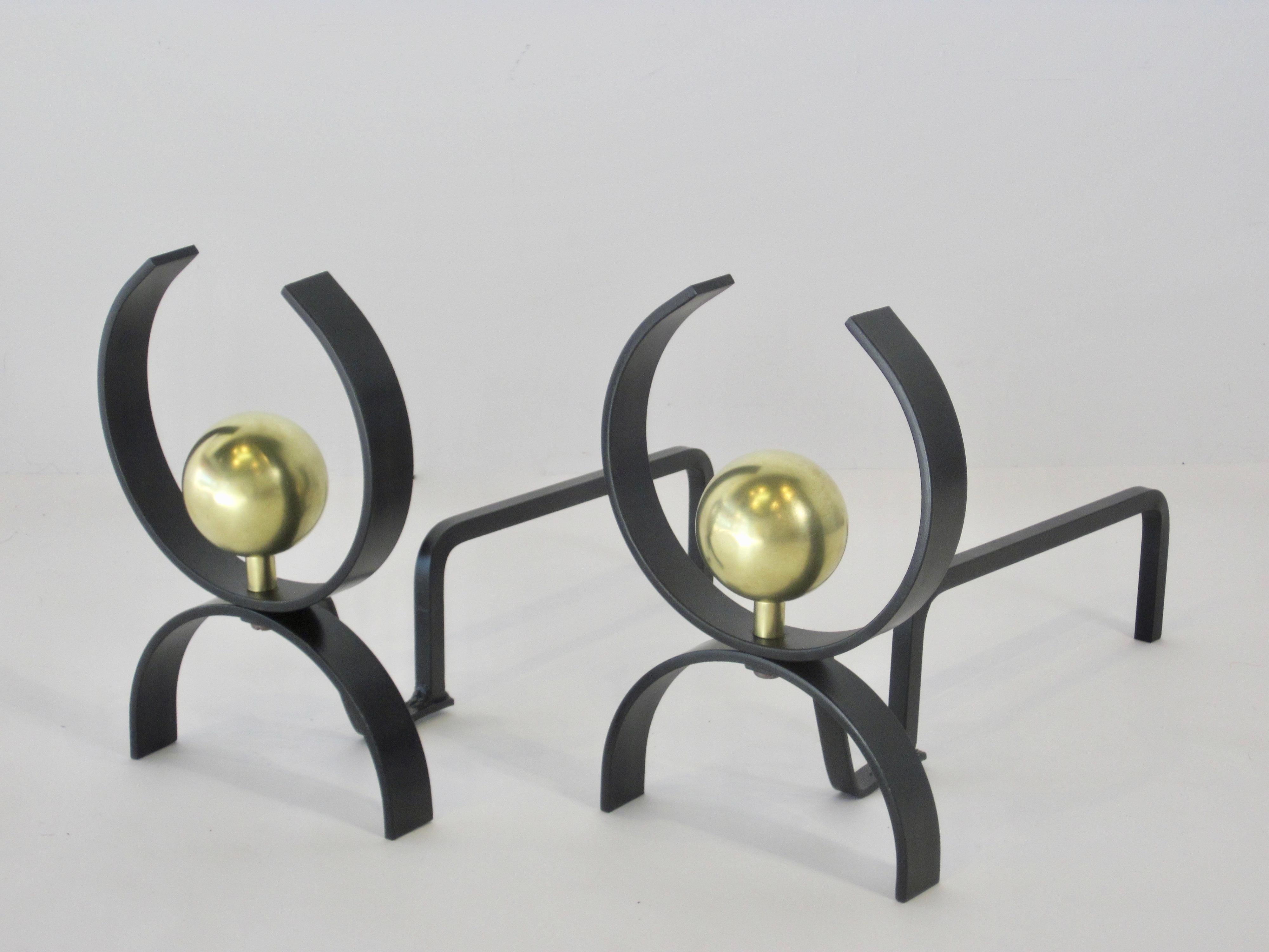 A pair of Art Deco style black iron and brushed brass concentric fireplace andirons by Donald Deskey. c.1950s 
Grosse Pointe, Michigan provenance.