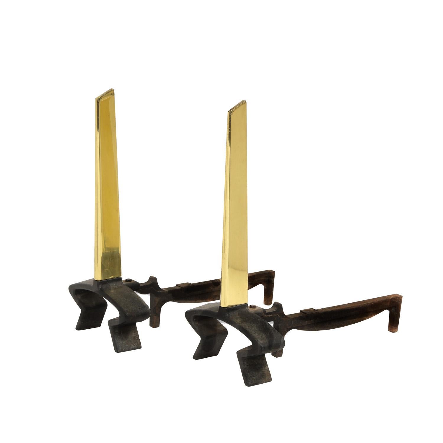 Pair of andirons in wrought iron with polished brass fins by Donald Deskey for Bennett, American 1950's (signed “Bennett” on shanks).  Deskey, a legendary designer created beautiful andirons.  These have been completely restored - brass polished and