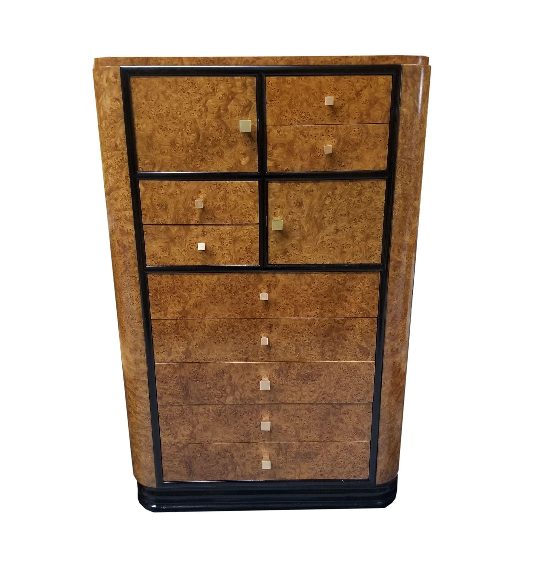 Original English European high-style Art Deco bronze highboy dresser featuring a stepped black lacquer base, black trim, and bird's-eye maple body. Each drawer features custom-made solid cast bronze pulls.

Measurements:

Height: 51.5