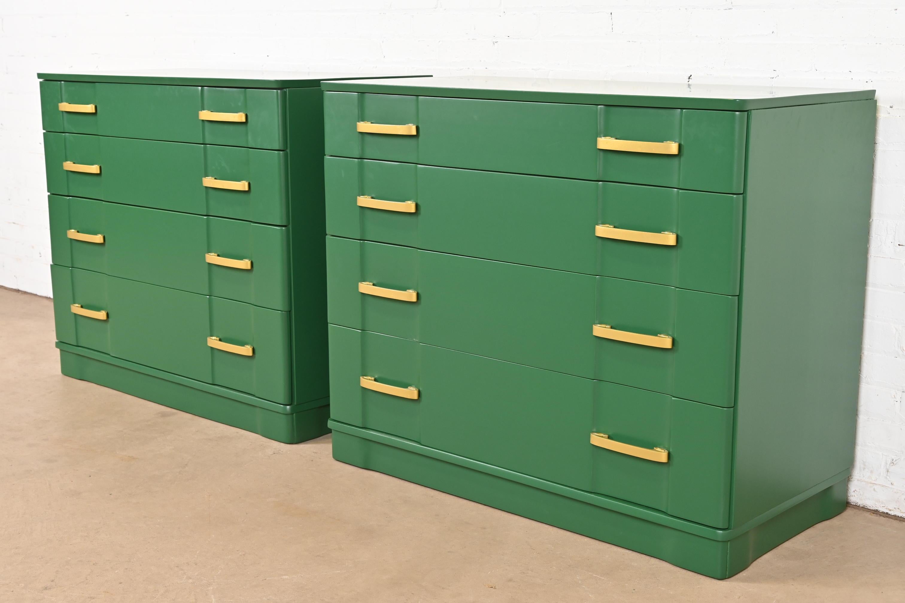 A gorgeous pair of Art Deco or Mid-Century Modern dressers or chest of drawers

In the manner of Donald Deskey

USA, Circa 1930s

Green lacquered mahogany, with original brass hardware.

Each measures: 41.75
