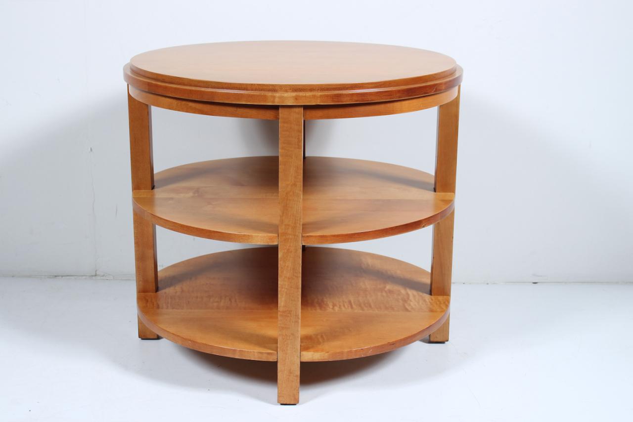 Art Moderne GIlbert Rhode Style Round  Maple Three Tier Corner Table. Featuring a two layer solid staved Maple circular surface, two Maple shelves (7.5H between each level), with four inset Maple legs. With floor taps. Excellent storage. Versatile.