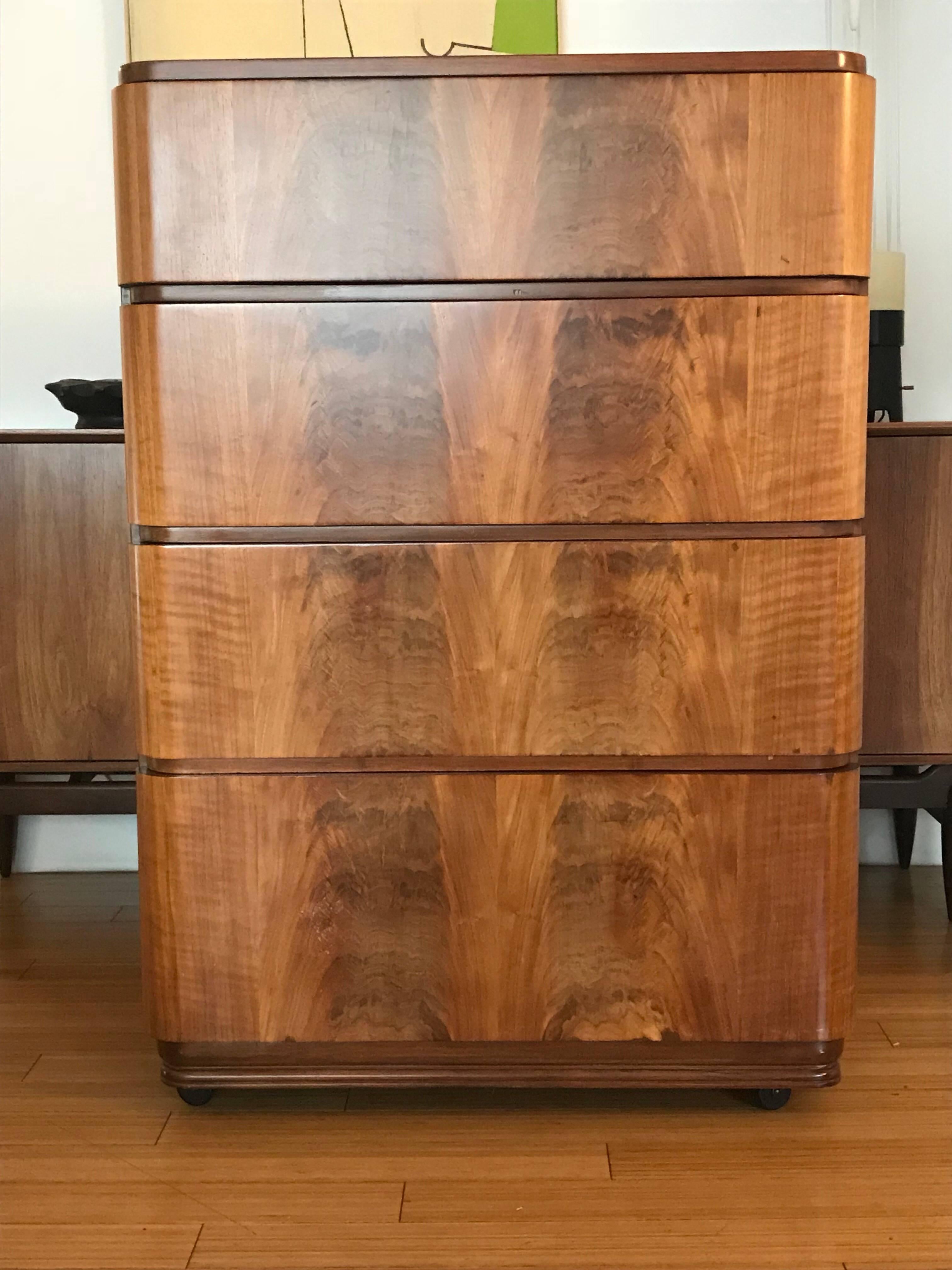 A nice minimalist form and function design.
Made of plywood (no press-board) with walnut veneer.
A beautifully grained natural satin.
It appears to have been refinished a few years ago.
It has four nice deep drawers to hold lots of stuff.
The