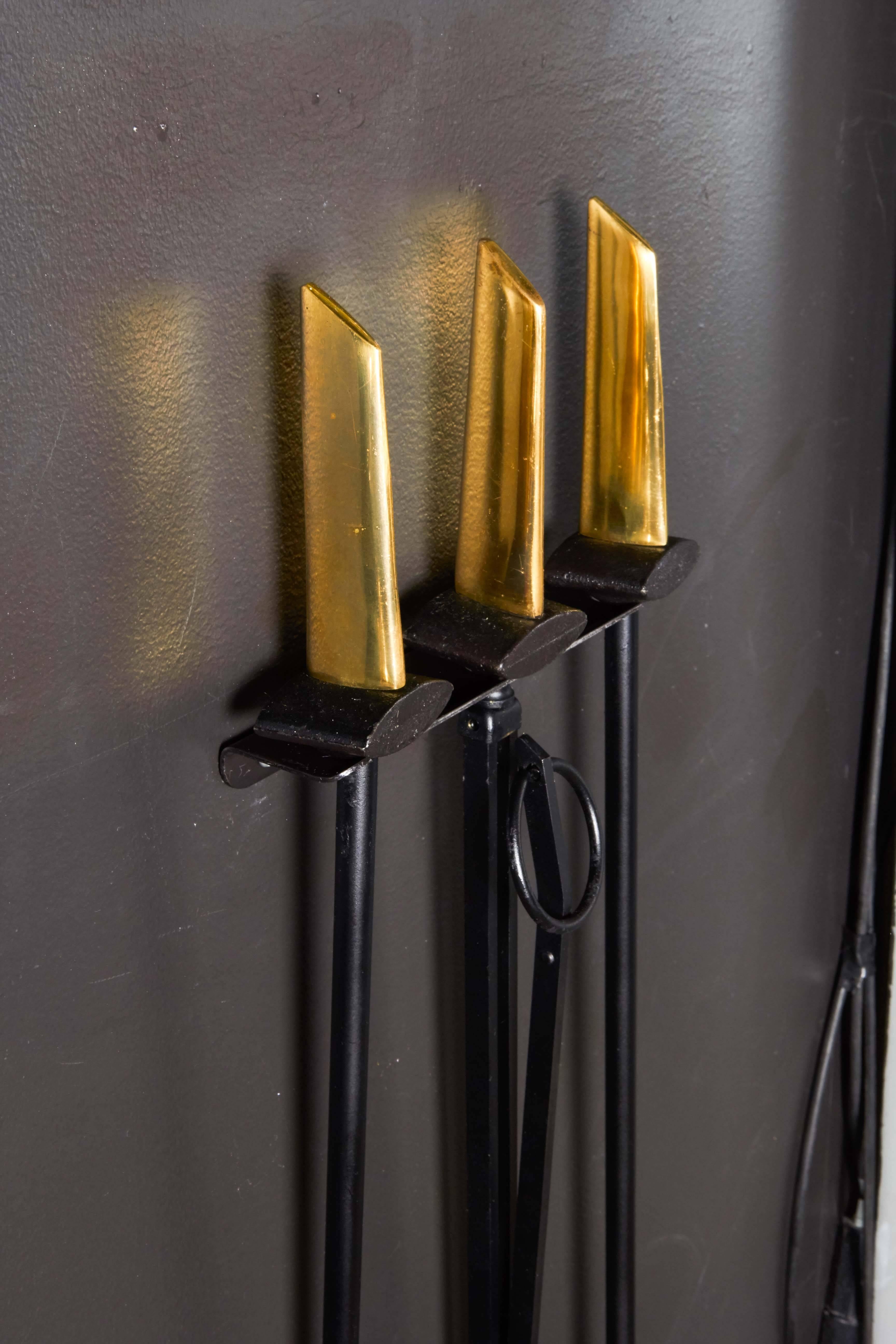 Mid-20th Century Donald Deskey Wall Mounted Fireplace Tools in Brass and Black Iron, c. 1950's