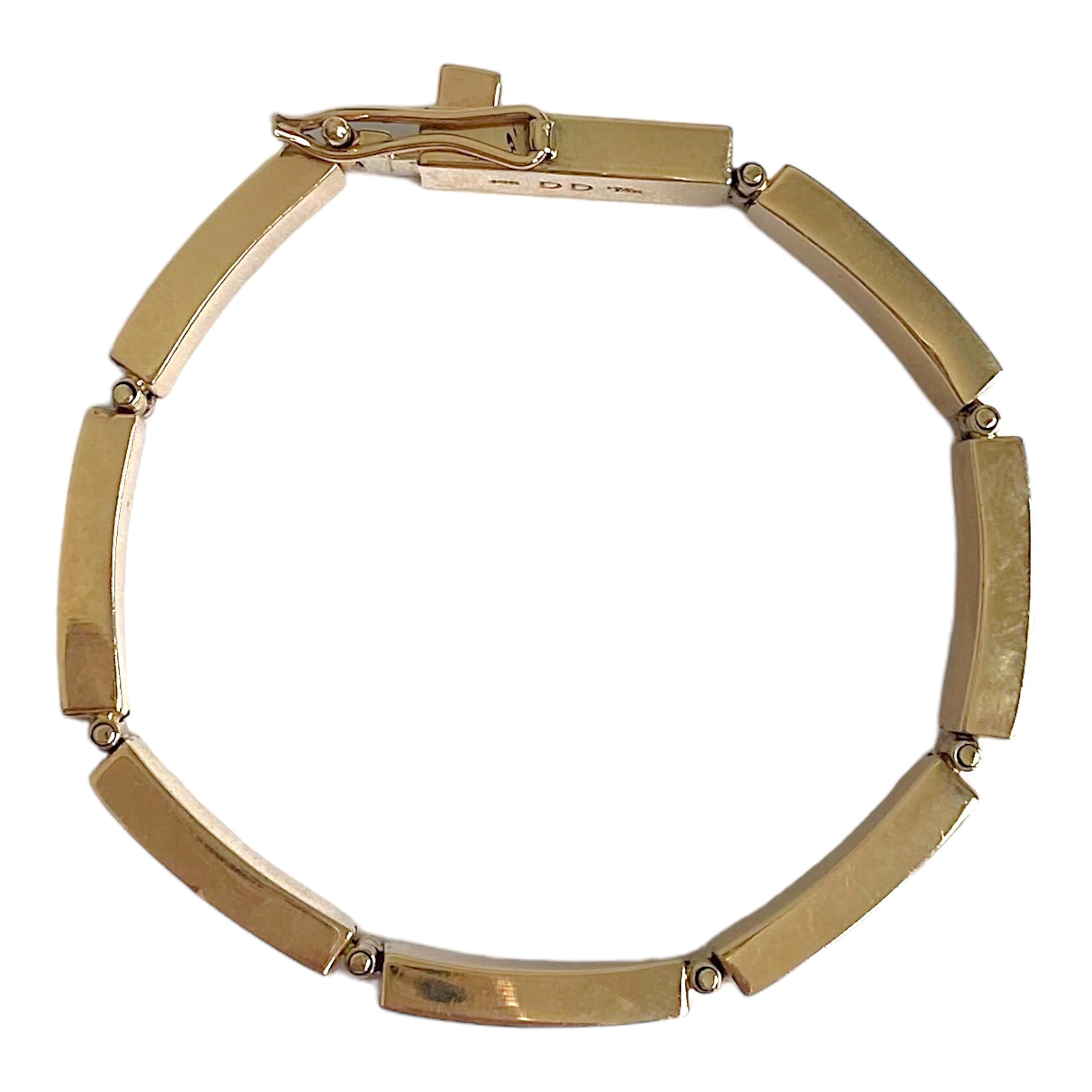 14K yellow gold Native American Navajo bracelet by Donald Douglas. The bracelet is composed of seven rectangular bar links, each set with inlayed opal and lapis lazuli.
Bright polish finish, large box clasp with safety.
Measurements: 
Length: 7