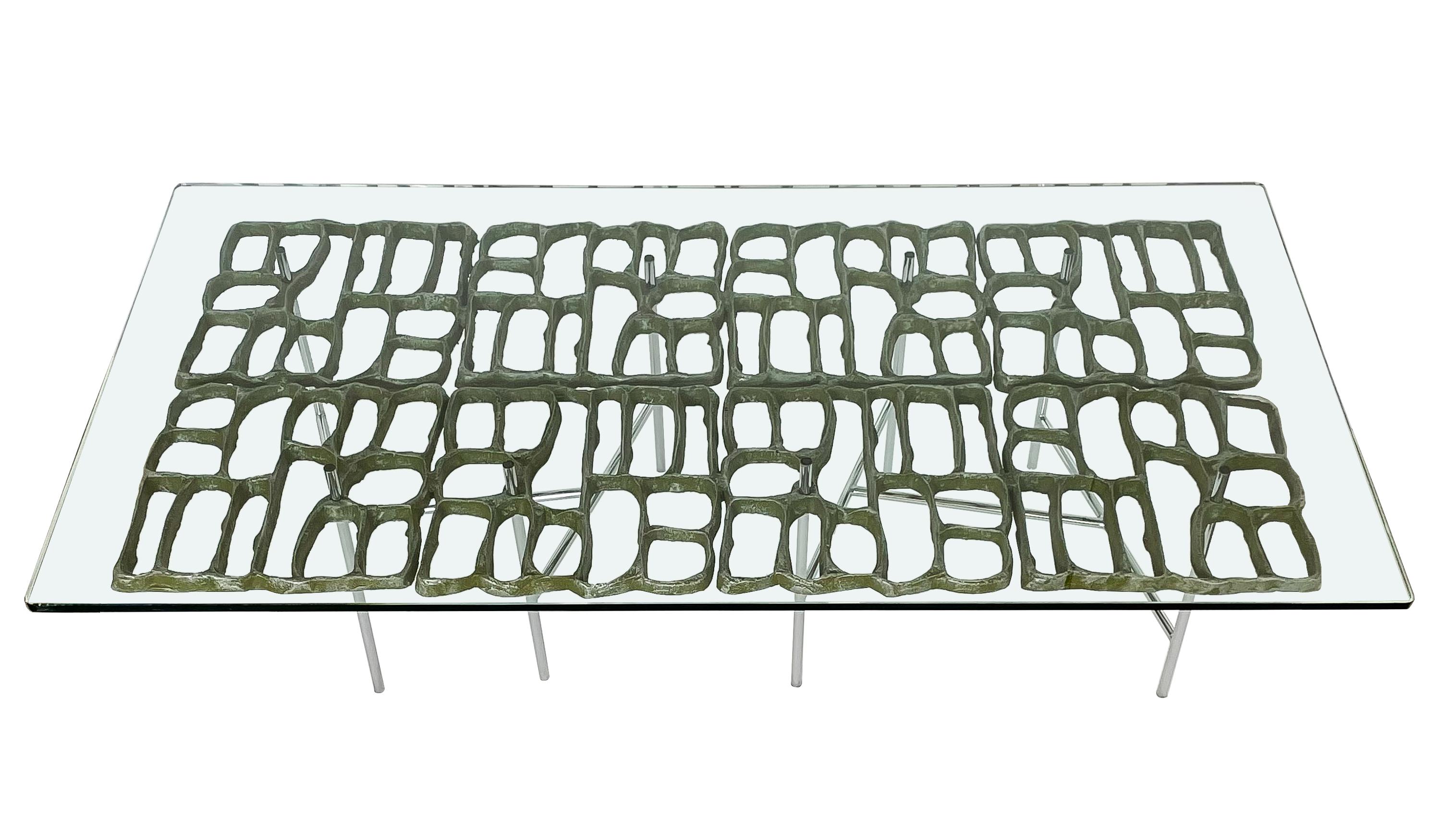 Brutalist sculptural cast aluminum coffee table by Donald Drumm, circa 1960s. This coffee table features an abstract cast aluminum open fretwork design with an applied patina in a beautiful dark green verdigris. The patina is washed over the