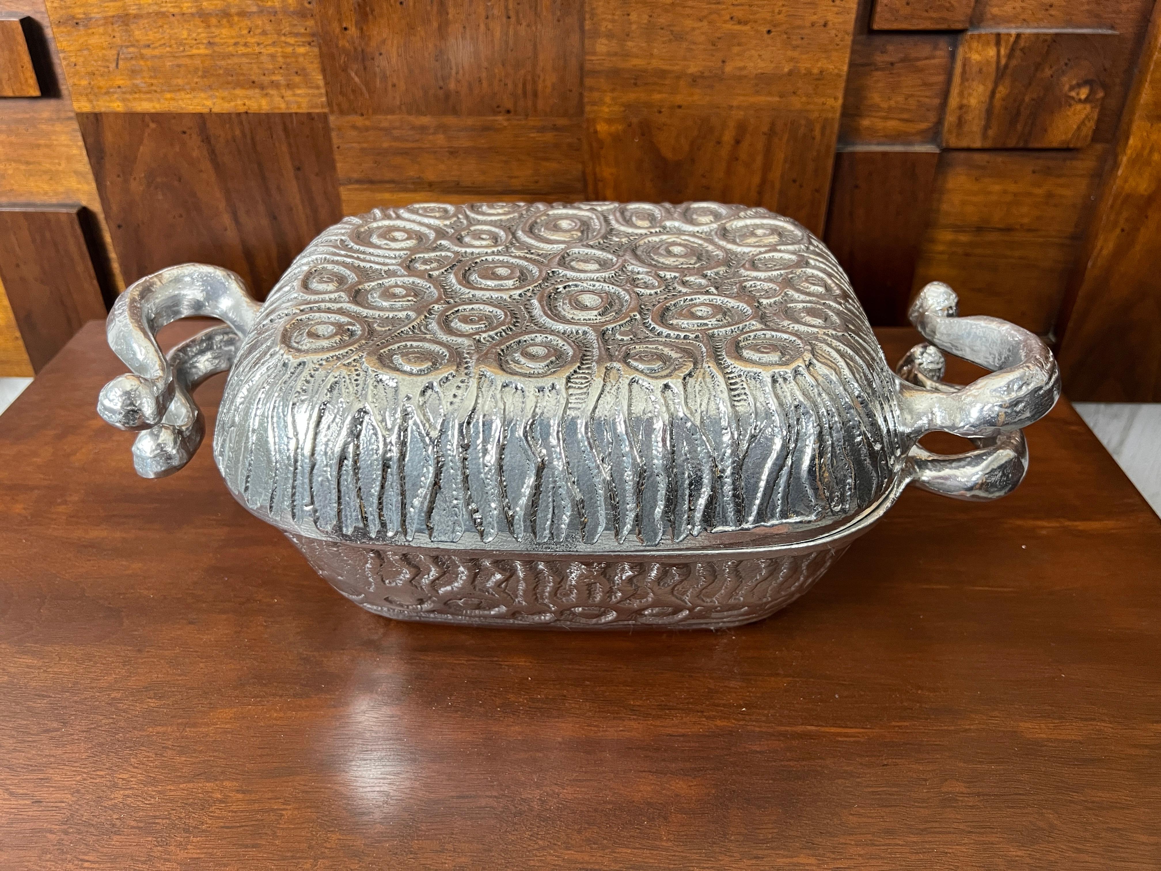 Vintage casserole dish with covered lid by Donald Drumm.  Obviously this has never been used by it's condition, Cast aluminum with a festive design on the exterior. Great for entertaining.