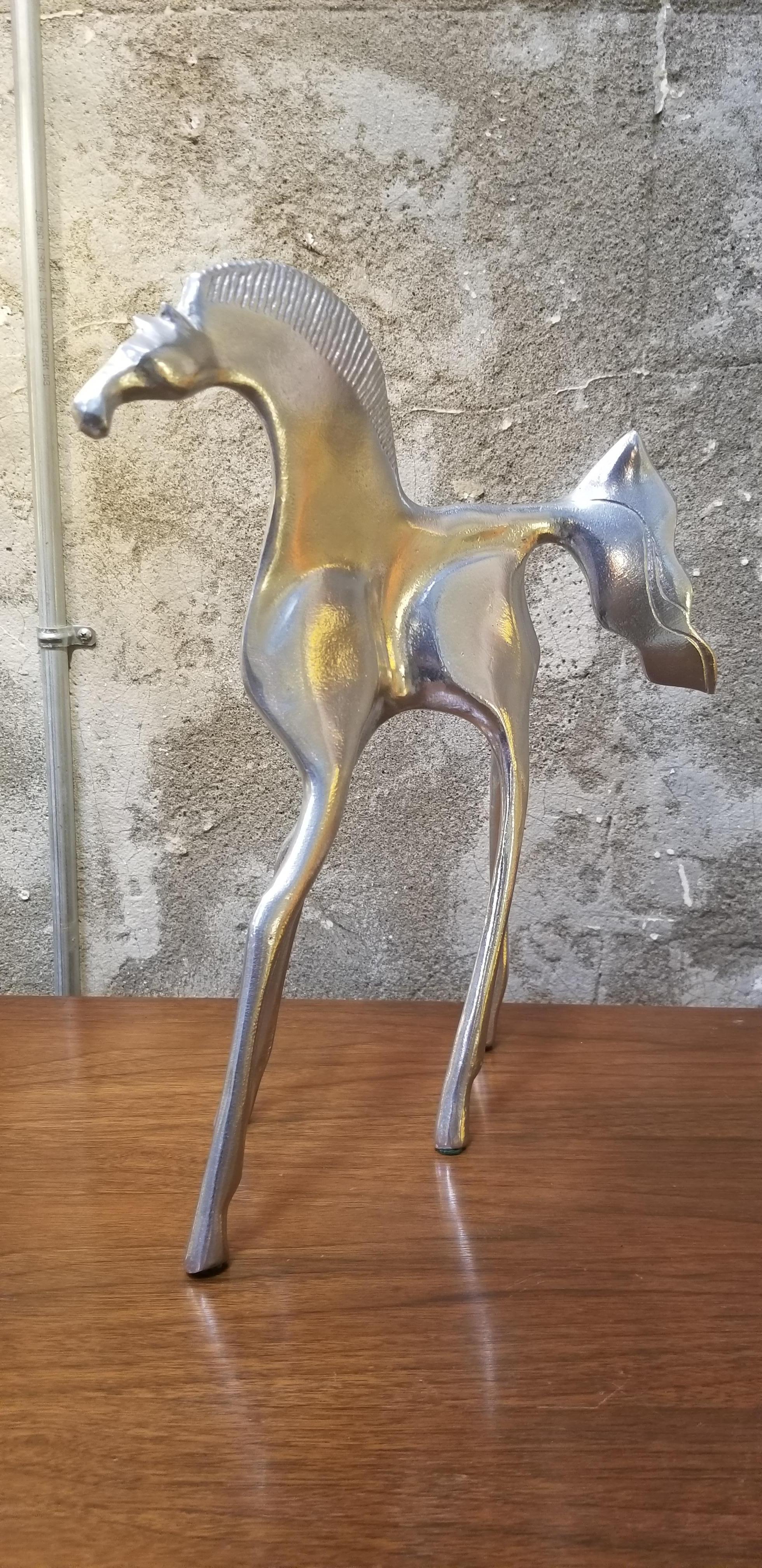 Stylized figure of a horse by Donald Drumm. Circa. 1970's. Signed.

Don Drumm (born April 11, 1935) is an American sculptor, designer and master craftsman based in Akron, Ohio. He was born in Warren, Ohio and received degrees in art from Kent