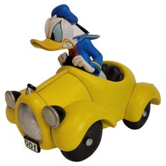 Vintage Donald Duck driving his yellow DD1 cabriolet