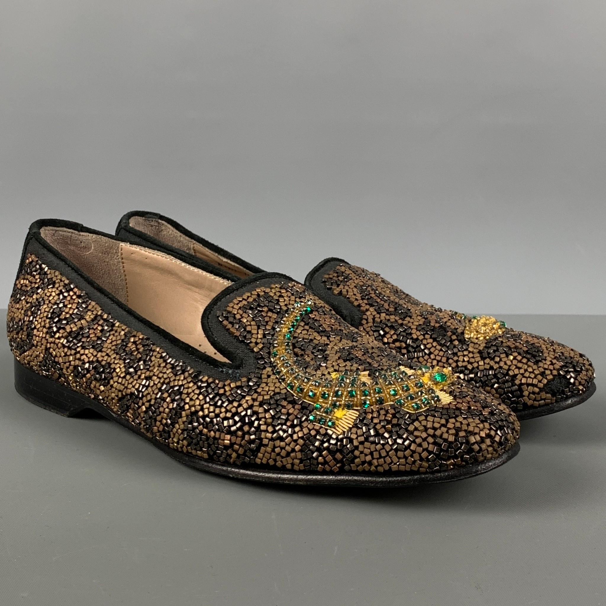 DONALD J PLINER SIGNATURE loafers comes in a black & gold beaded leather featuring a beaded crocodile design, slip on style, and a square toe. Made in Italy.

Very Good Pre-Owned Condition.
Marked: 8 1/2  M

Outsole: 11 in. x 3.5 in.  

SKU:
