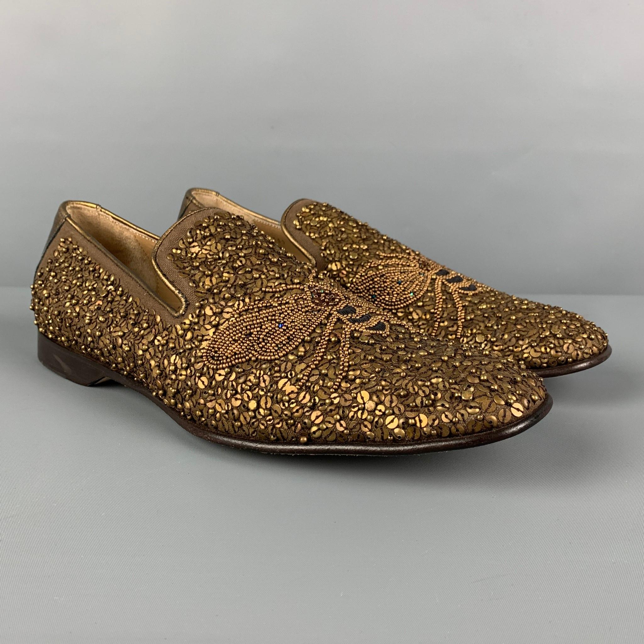 DONALD J PLINER loafers comes in a gold & brown sequined leather featuring a butterfly design and a slip on style and a square toe. Made in Italy. 

Very Good Pre-Owned Condition.
Marked: 9 M

Outsole: 12 in. x 4 in. 

 