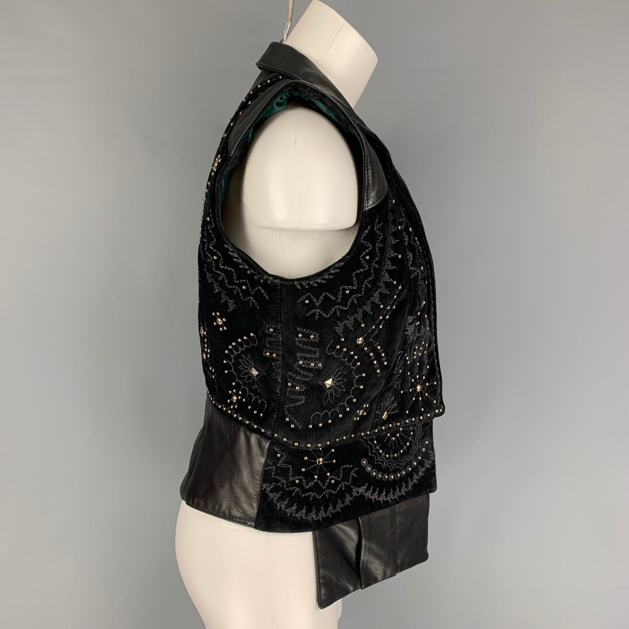 DONALD J PLINER vest comes in a black leather featuring hidden panel pocket details, studded embellishments, spread collar, embroidery, and a hidden placket closure.
Very Good
Pre-Owned Condition. 

Marked:   SML 

Measurements: 
 
Shoulder: 15