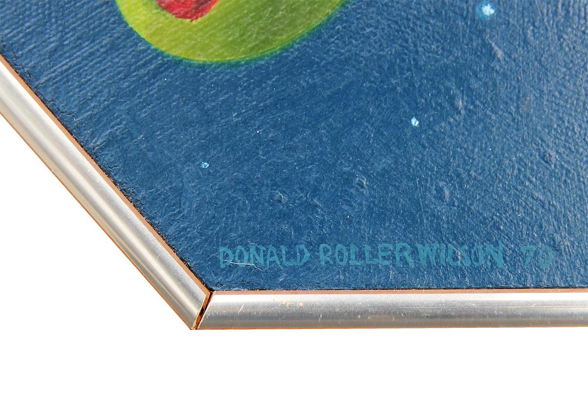 Modern hyperrealist painting of a cow surrounded by floating olives by Texas artist Donald Roller Wilson. The work is hung in a hexagonal frame, adding an additional layer of interest. Signed and dated along front lower margin. 

Artist Biography: