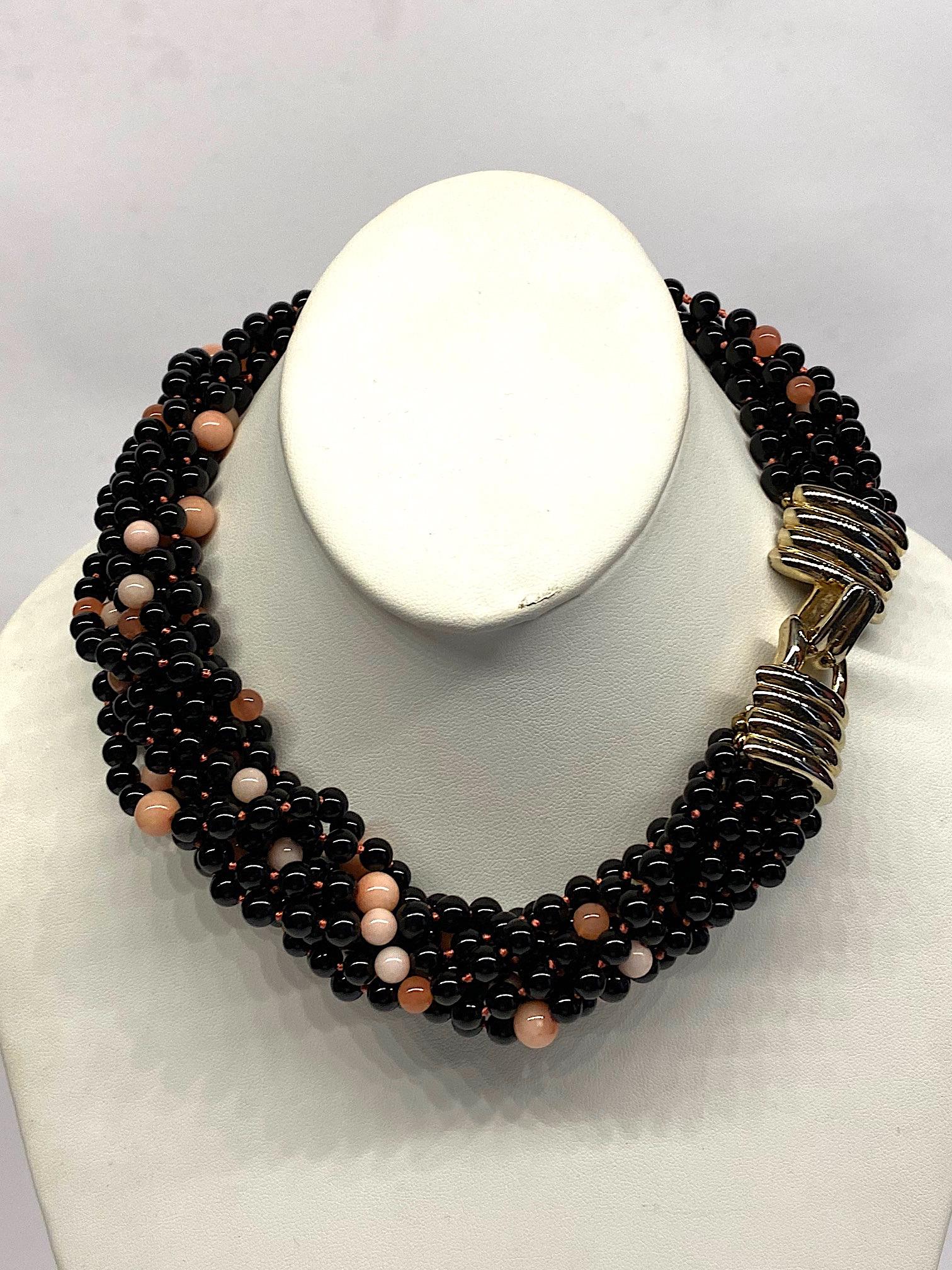 A wonderful 1980s ten strand necklace of black glass and natural rose quartz beads from fashion jewelry designer Donald Stannard. The black beads are 5.4 mm. The rose quartz are 5.2 and 6.8 mm in size. The beads are strand on matching rose color