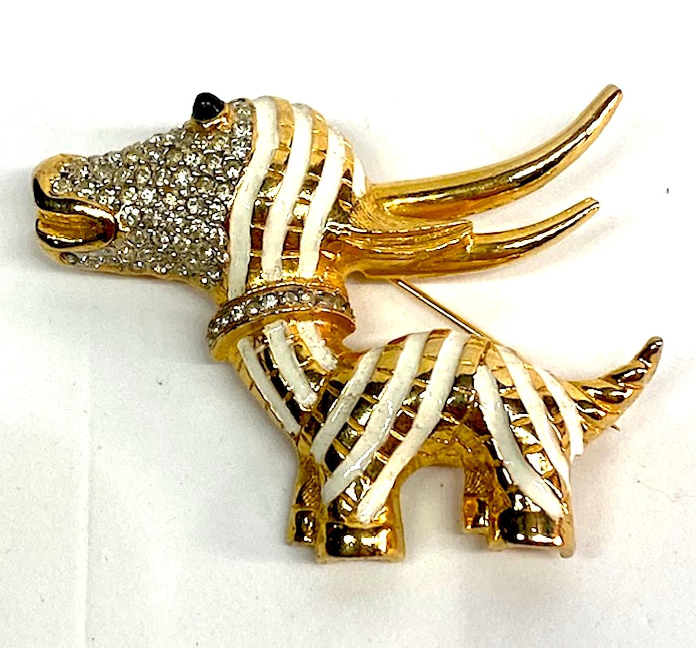 A wonderful interpretation of an African stripe antelope by famous costume jewelry Donald Standard. Donald was Kenneth Jay Lane's assistant until 1972 when he opened his own jewelry company. This piece has a rich gold plate with white enamel