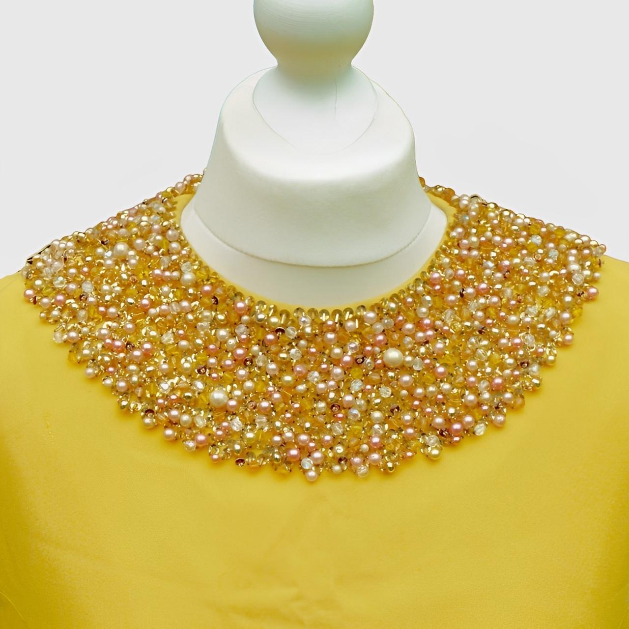 
Wonderful Donetti Milano canary yellow sleeveless shift dress, lined in yellow satin. Featuring a beautiful wide beaded neckline, with pearls, sequins and glass beads. The dress has a back zip.

The material is in good condition. The collar has