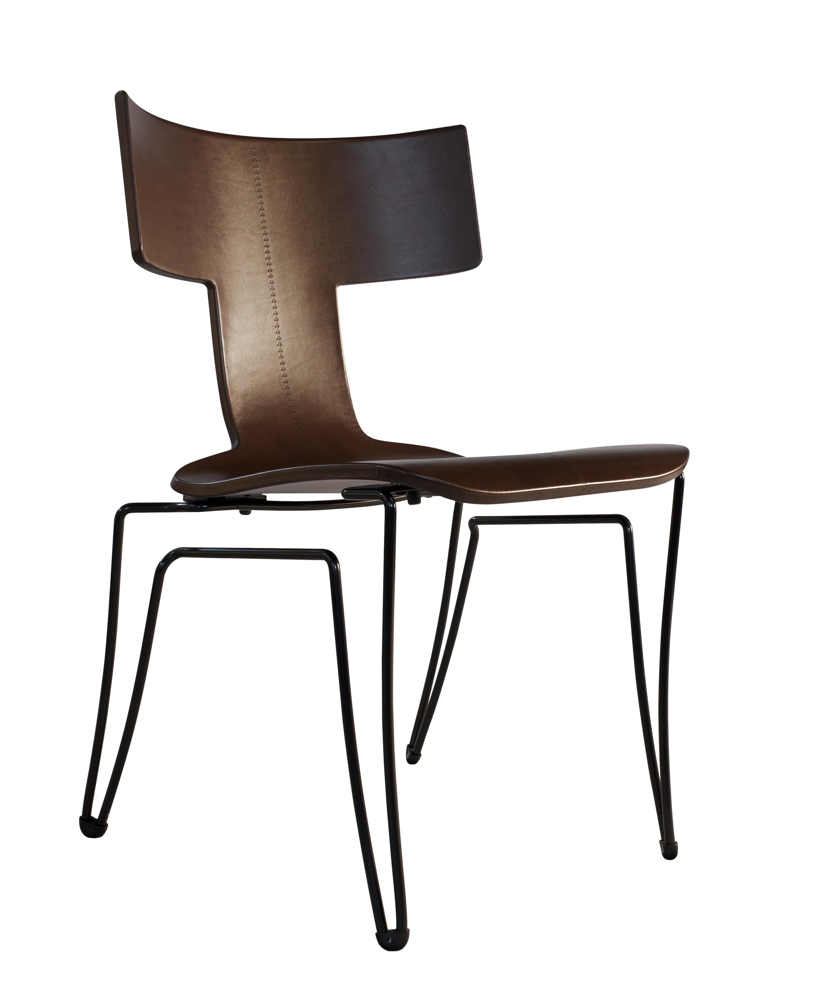 With its combination of simplicity and ingenuity, the Anziano has become one of Donghia's emblematic pieces. Chair with a molded shell of beech wood veneer available in stained, lacquer, or leather finishes. Base made of black powder coated steel.