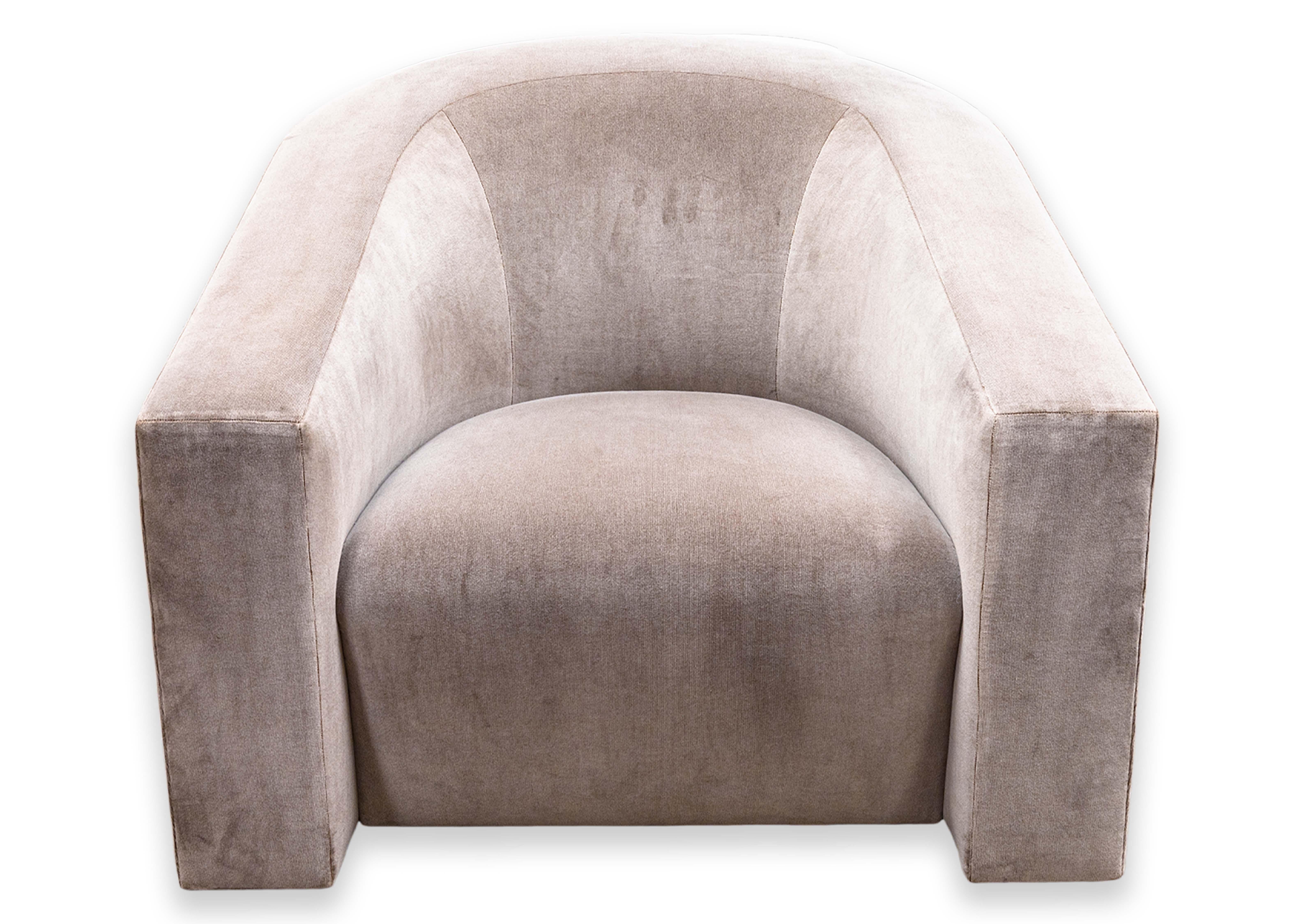 A Donghia barrel backed volume tub chair. This is a wonderful contemporary modern accent lounge chair with a truly wonderful mohair velvet upholstery. The color of the fabric is a mix of grey and pink, a very soft color. This piece features a very