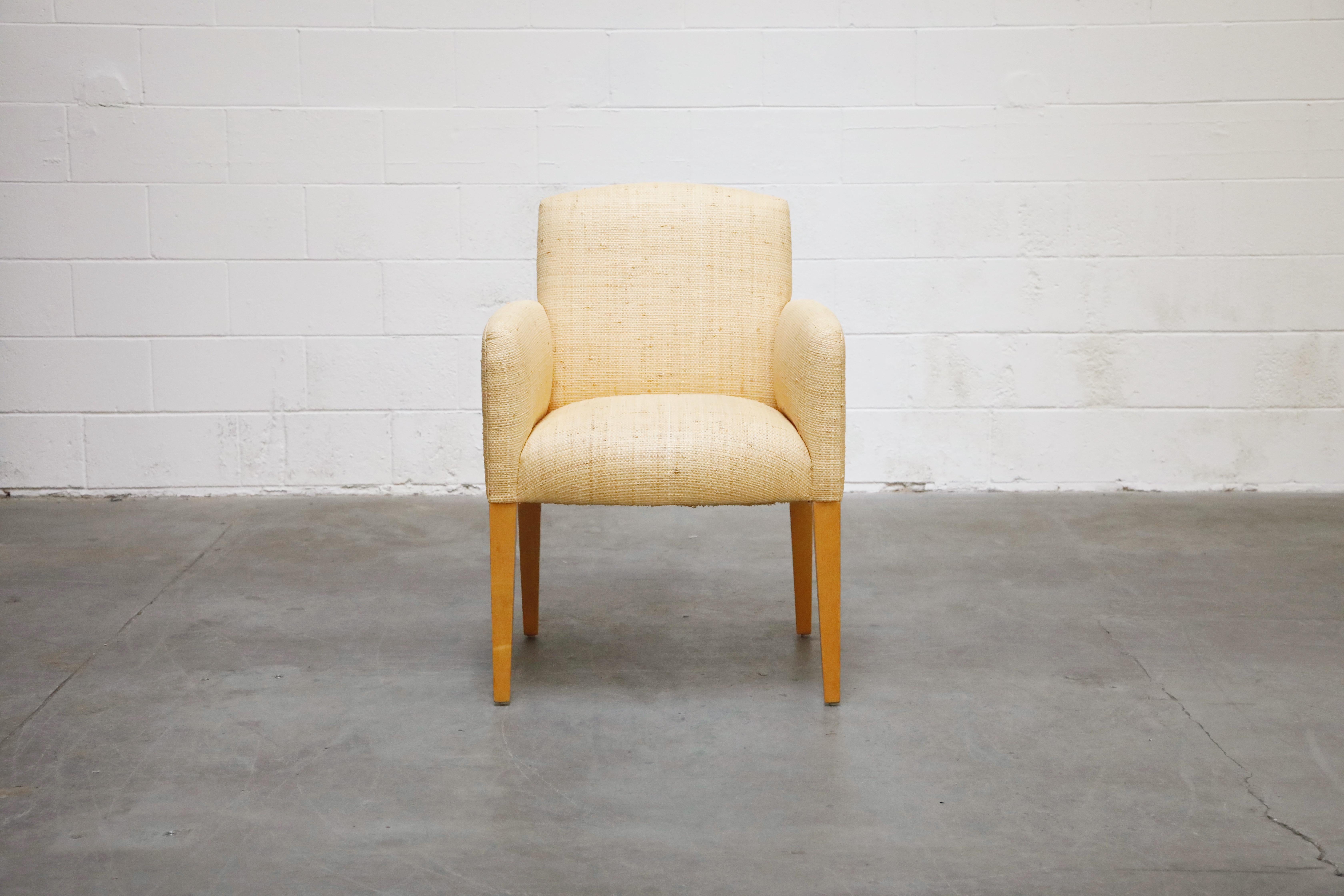 This lovely custom order Plaza armchair from Donghia features beautiful grass cloth fabric upholstery over wood legs. From the original receipt, we found that this chair was custom upholstered in woven bleached grass cloth. The wood has been