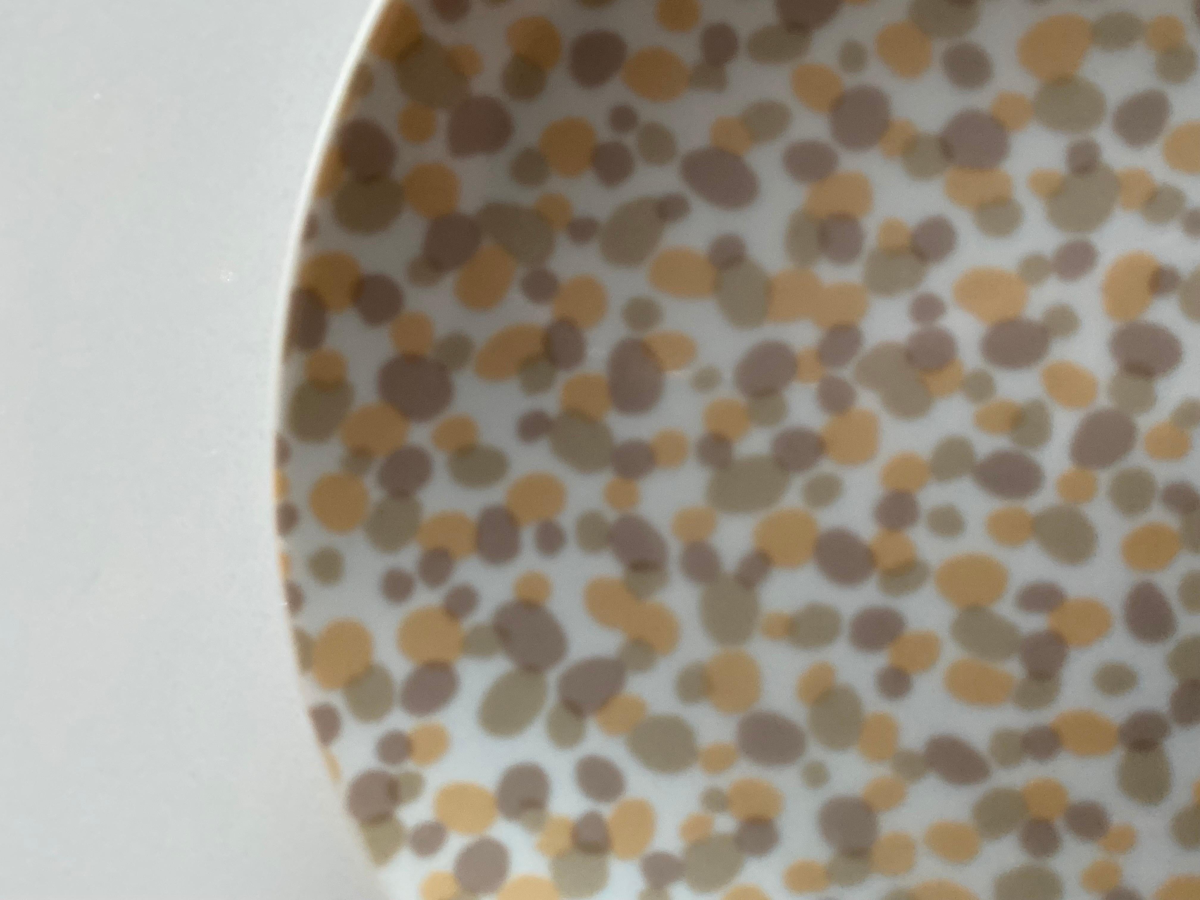 A dessert plate by Angelo Donghia for Tuscany in the Confetti pattern, a free form earth-toned neutral design.

Japan, circa 1970.

Each plate measures 7-5/8 inches wide.