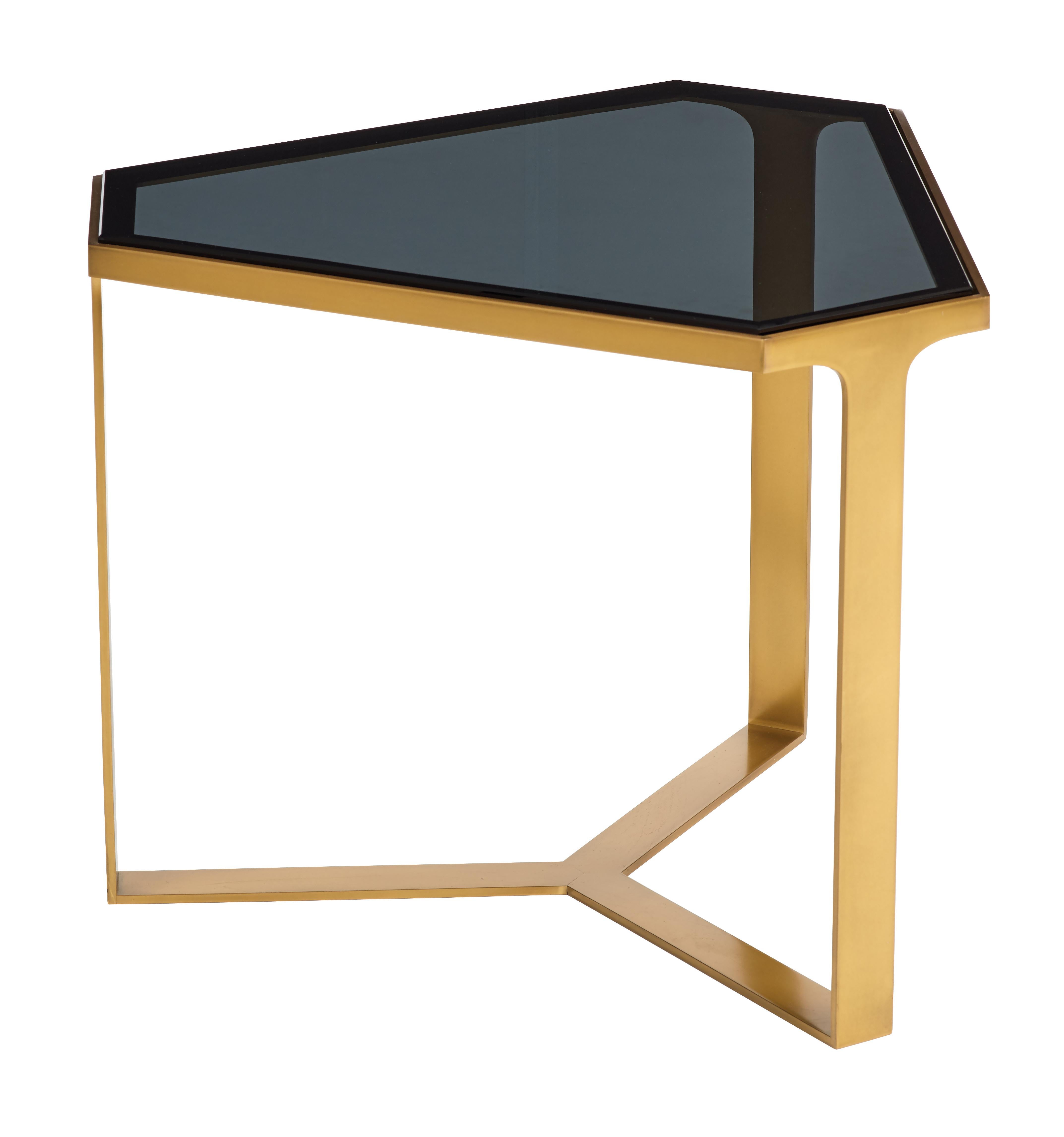 The root of conception for the Forma table is that of its Latin meaning; form, shape and beauty. The Forma table embodies each of these characteristics, all paramount during the design process. Triangular shaped table in high luster satin brass or