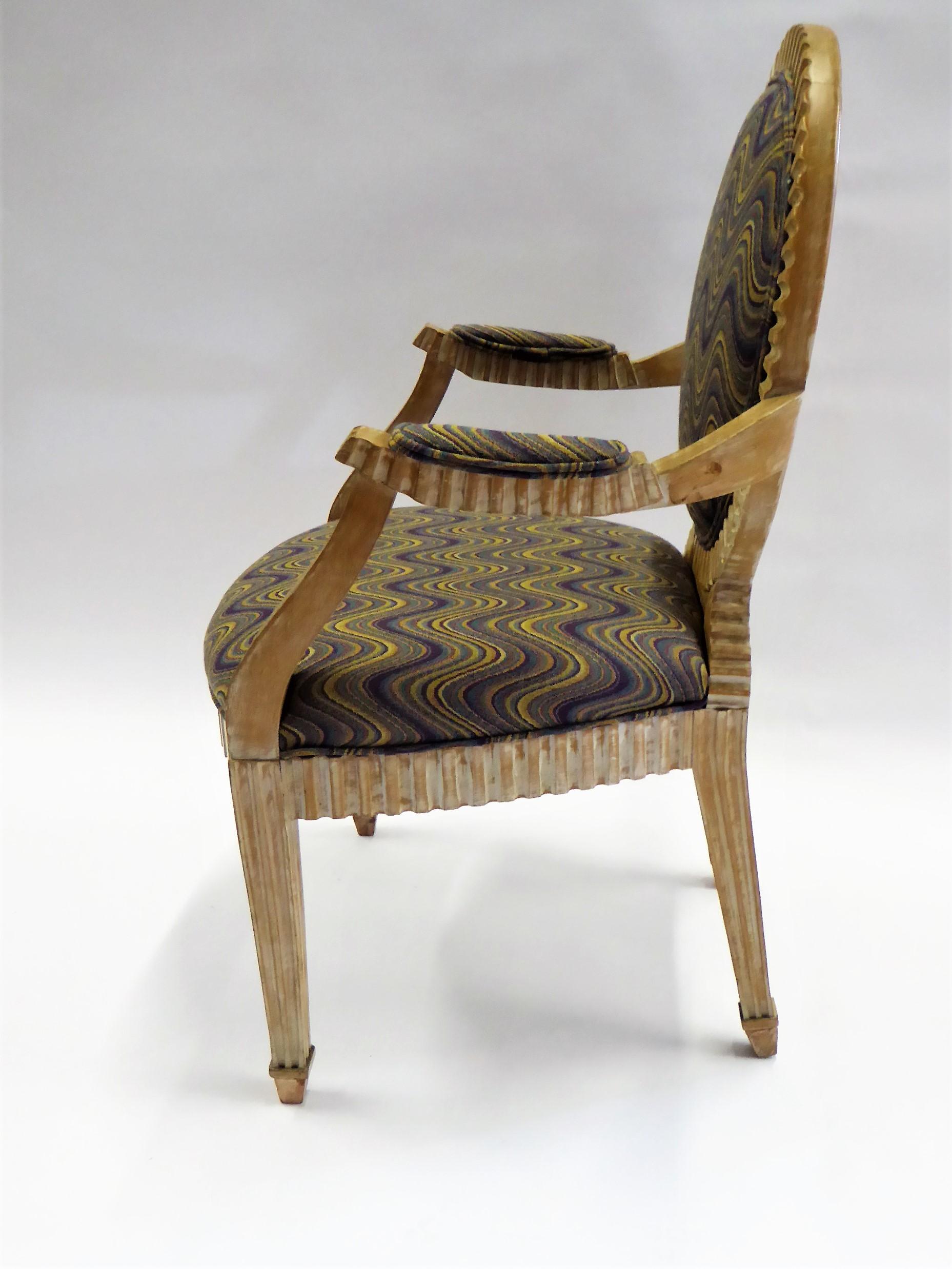 REDUCED FROM $1,050....In the style of John Hutton's Soleil design for Donghia, this fluted and cerused armchair is magnificent. Newly upholstered in a modern flame stich weave and with a raffia upholstered back. Wood under seat stamped made in