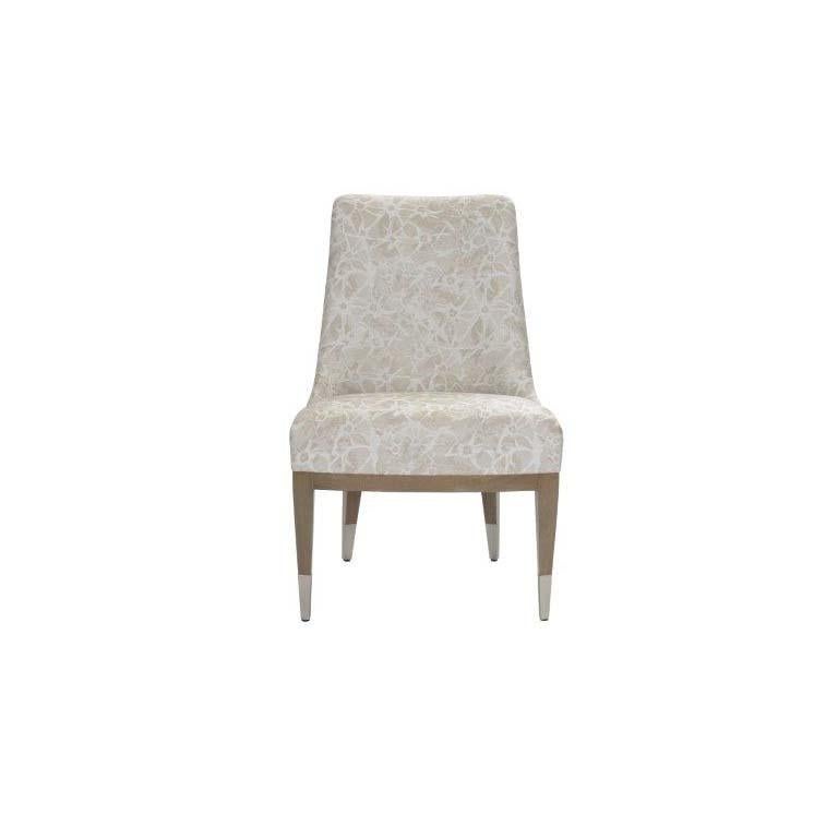 Named after a variation of the rope necklace, Lariat is a sophisticated dining chair with captivating spindle back details. This tight upholstered chair is made with solid mahogany and complimenting sabots. Every inch of this chair reflects the
