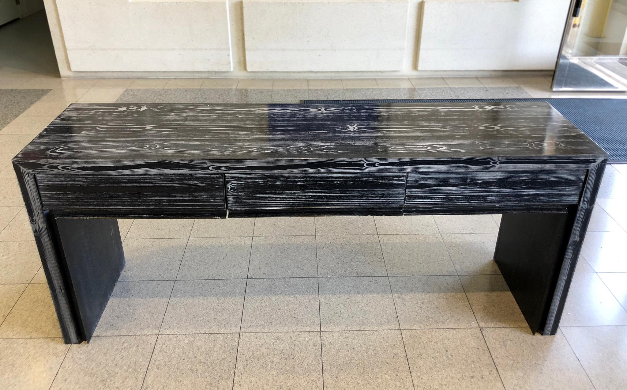 Hand-crafted oak desk designed by Joseph Jeup for Donghia's Legacy Collection. It is newly refinished in a ceruse coat of black-and-white. We love the rich woodgrain stripes that cover the surface, acting as the main decorative element on an