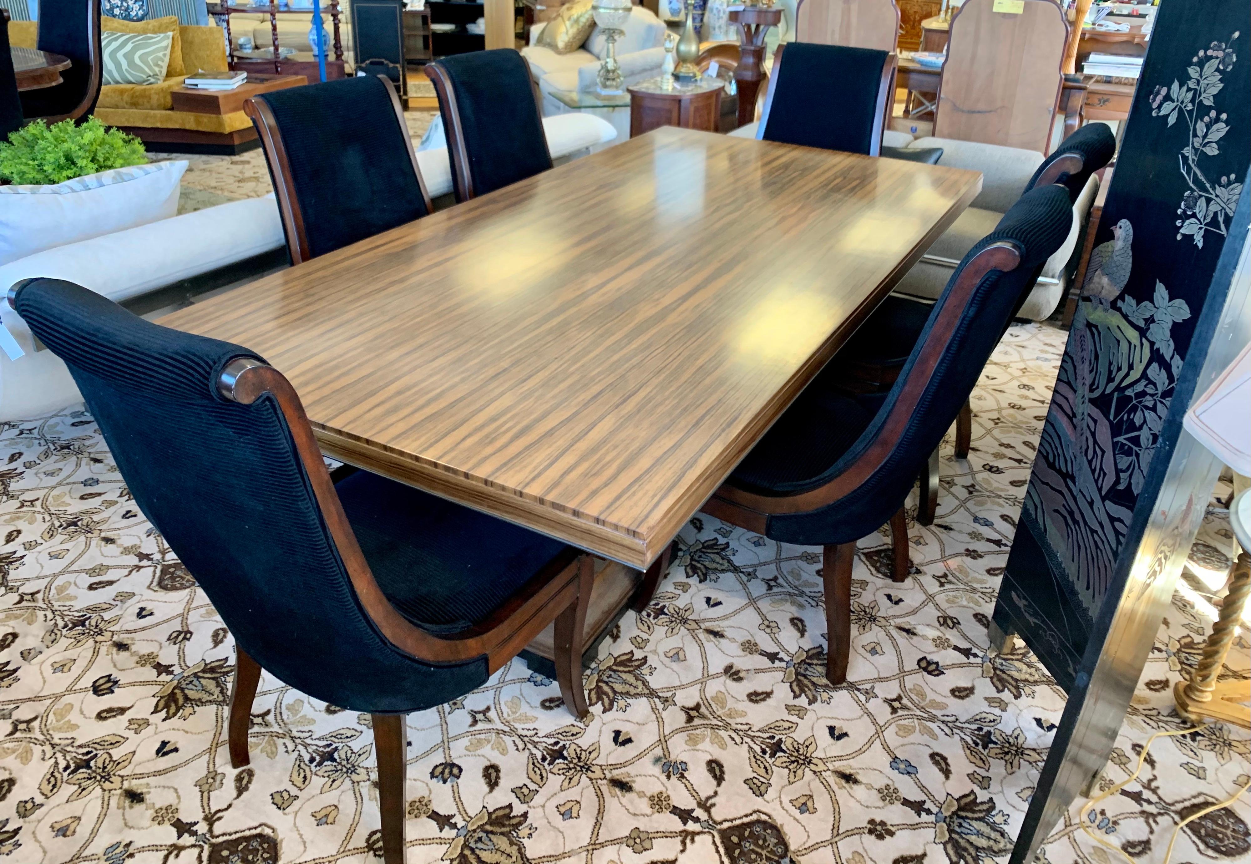 A rare and coveted Donghia London Laurent eight foot dining table which features two pedestals bases,
each consisting of four posts on a flared square base. Each post tapers and curves narrow towards the top, presenting the Lauren tabletop as a