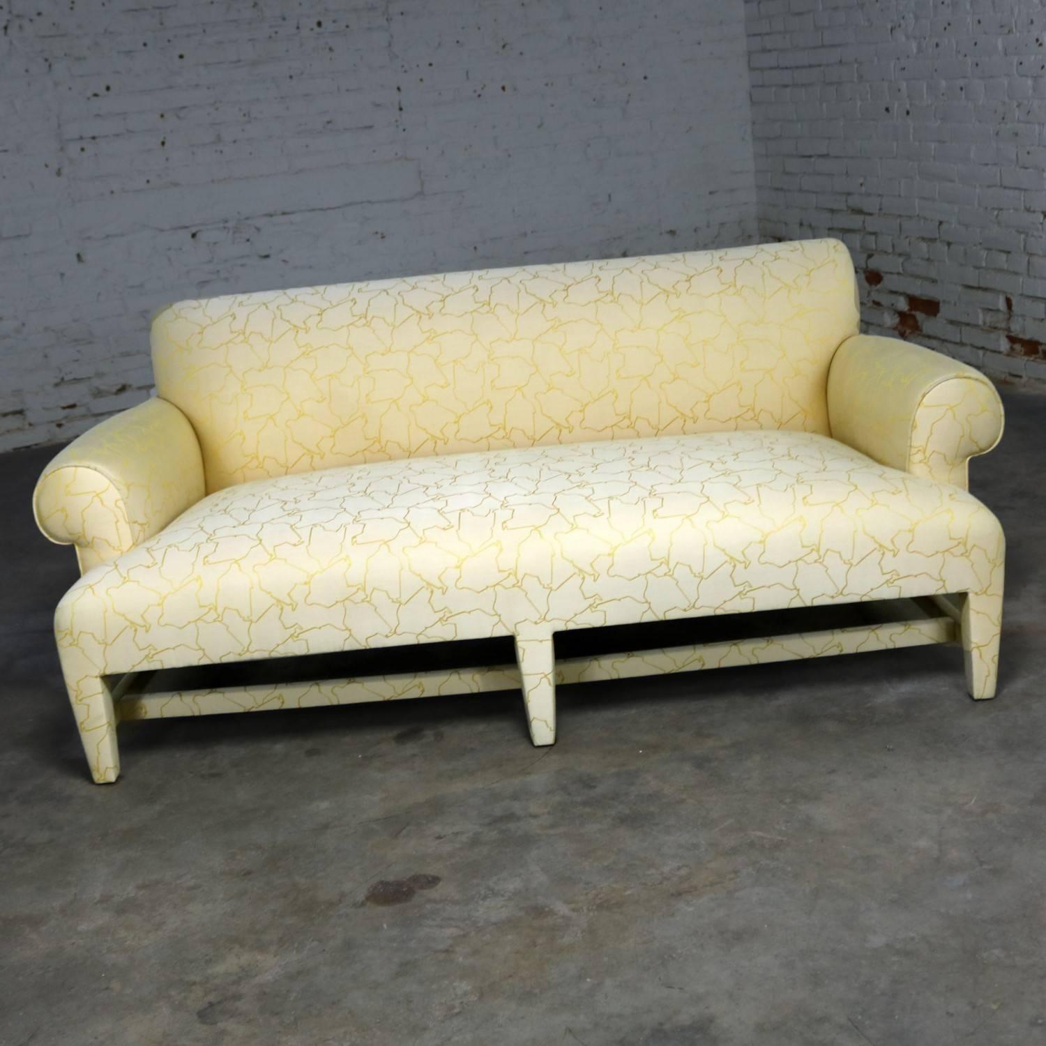 Extraordinary fully upholstered loveseat sized sofa by Donghia with design attributed to Angelo Donghia, circa 1980s. It retains its original label and original upholstery of cream and yellow with a fat man motif. It is unknown if this is a Donghia