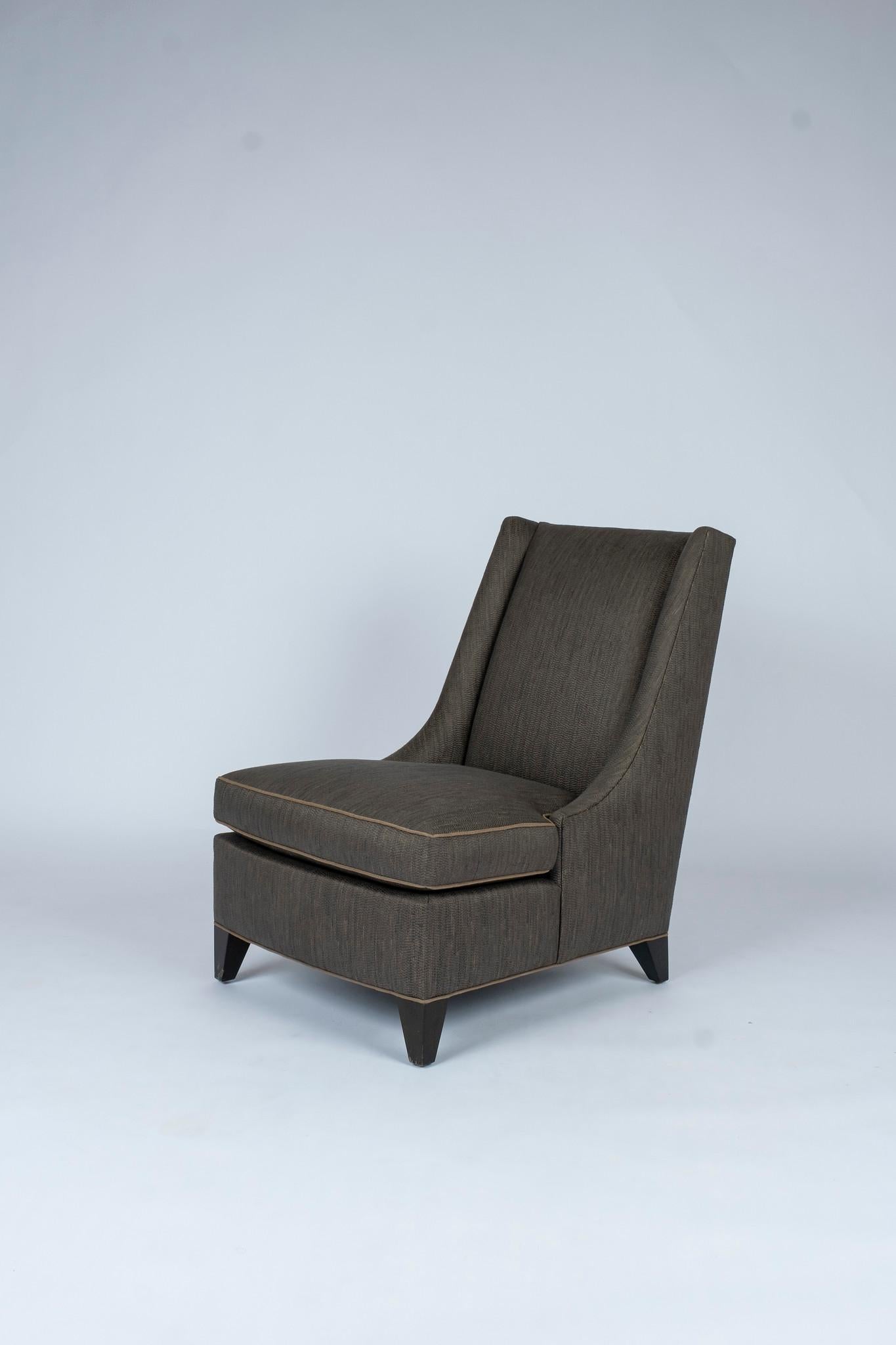 Donghia Milo slipper chair fully upholstered in dark taupe woven jacquard with loose seat, tight back, with feet finished in espresso stained maple wood.