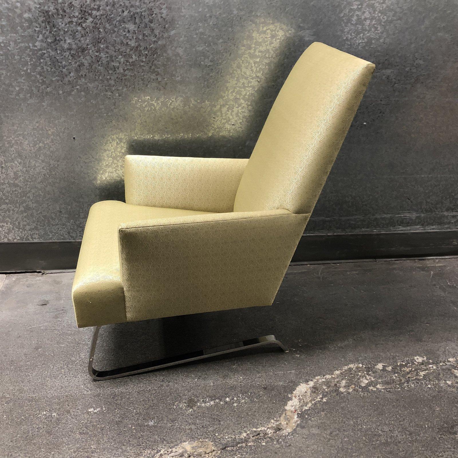 A Odeon club chair by Donghia. This piece features a dazzling patterned fabric, soft shapes, and a metal C framed base in a silver reflective finish. The high back, paired with the movement of the C framed base make this club chair as comfortable to