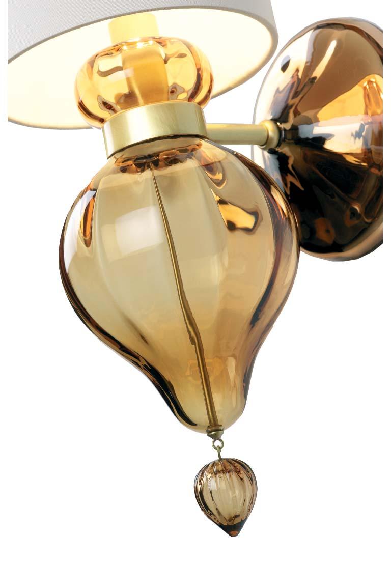 Fluid grace abounds in the handblown Murano torre sconce. Wall sconce in handblown Murano glass. Sepia glass, hand silvered glass and brass hardware.

- Back plate dimensions: 4.75