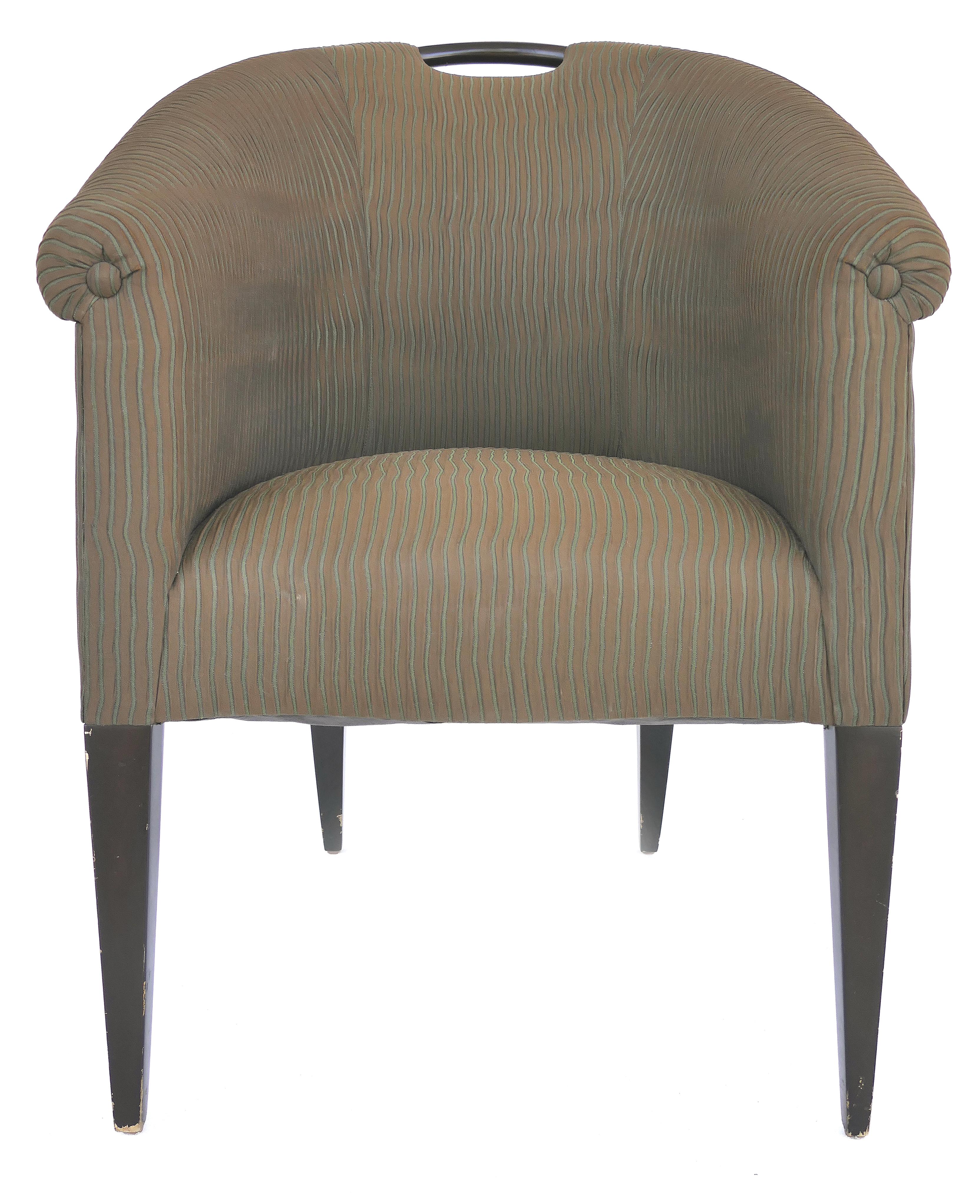 Donghia upholstered club chairs with wood handles

Offered for sale is a pair of upholstered club chairs by Donghia with a wooden handle at the top and sides that slant down to the arms. The chairs are supported by slender tapered legs. The chairs