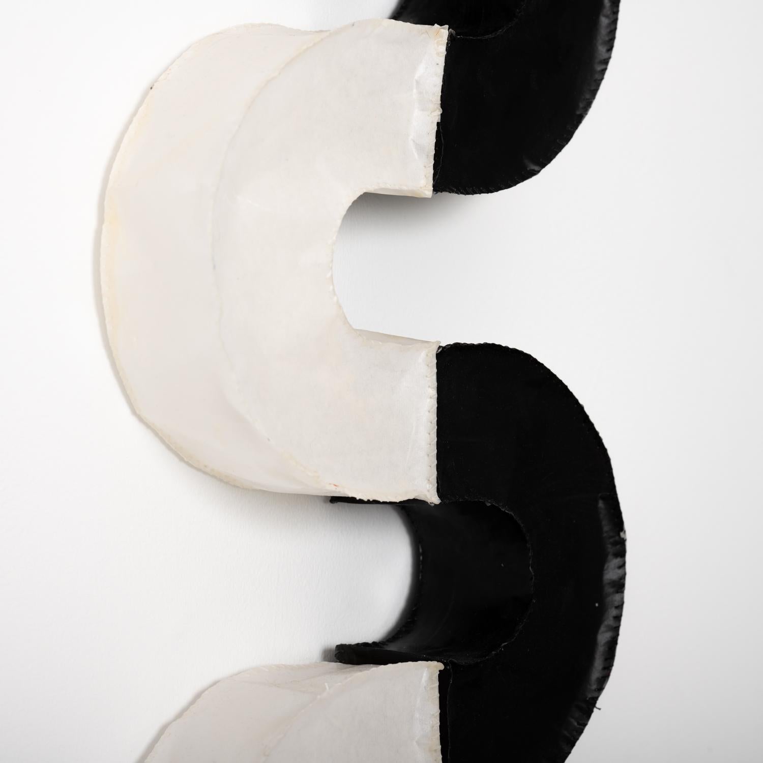 Abstract minimalist three-dimensional wall sculpture in black and white
