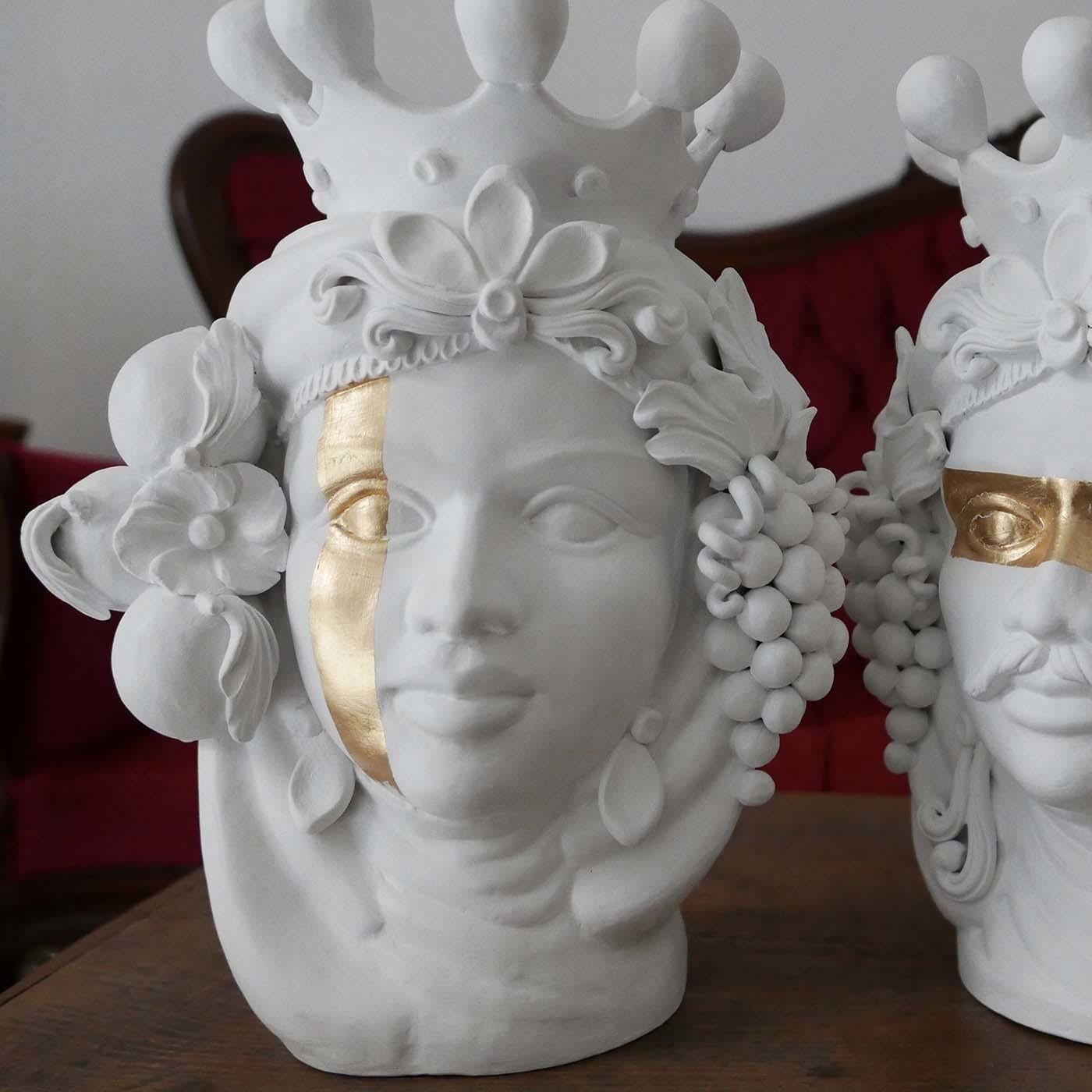 Distinguished for its deft use of sculptural details and simple colors, this handmade head vase will add dramatic flair to any kitchen, living room or entryway decor. This sculpture of a woman boasts a flawless white complexion framed by a supple