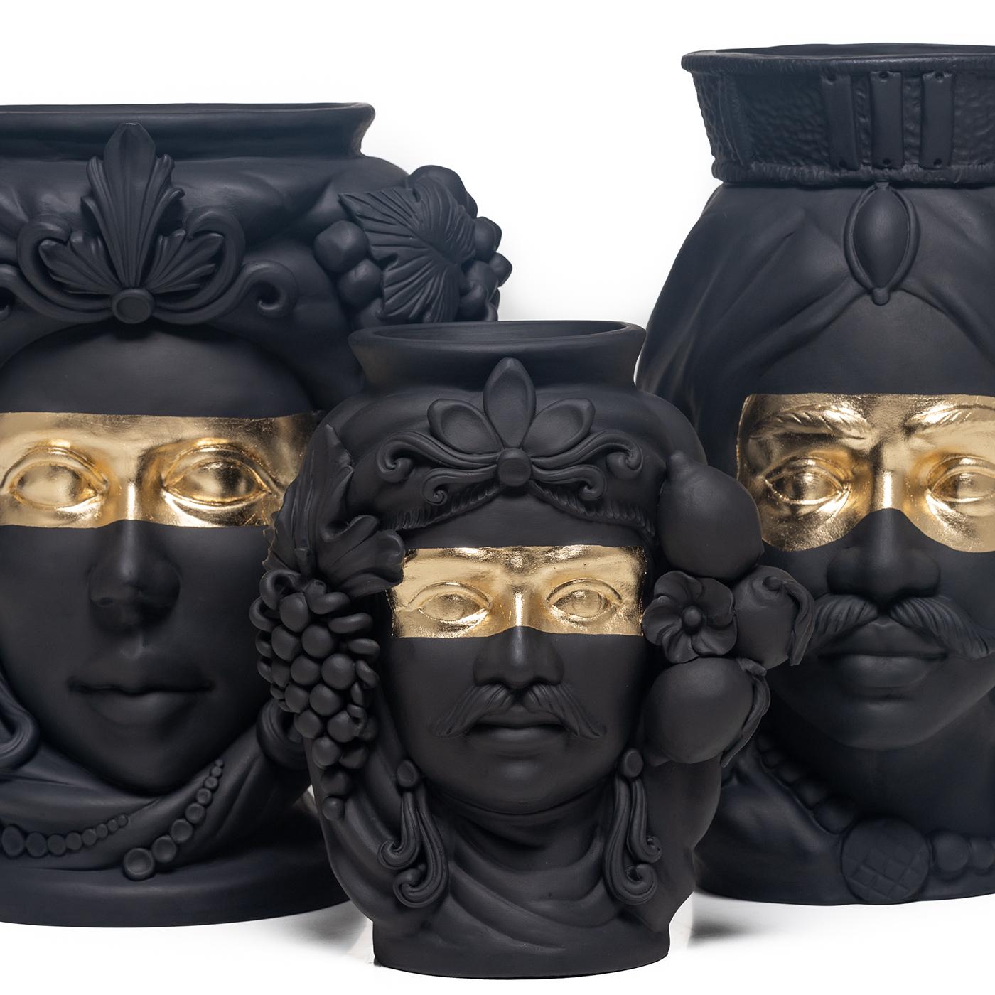 The grandeur of Sicily's Arab domination is celebrated in this anthropomorphic terracotta vase that depicts a Sicilian woman handcrafted by master ceramicist Stefania Boemi. The ceramic is hand-glaze in a deep matte black that enhances the